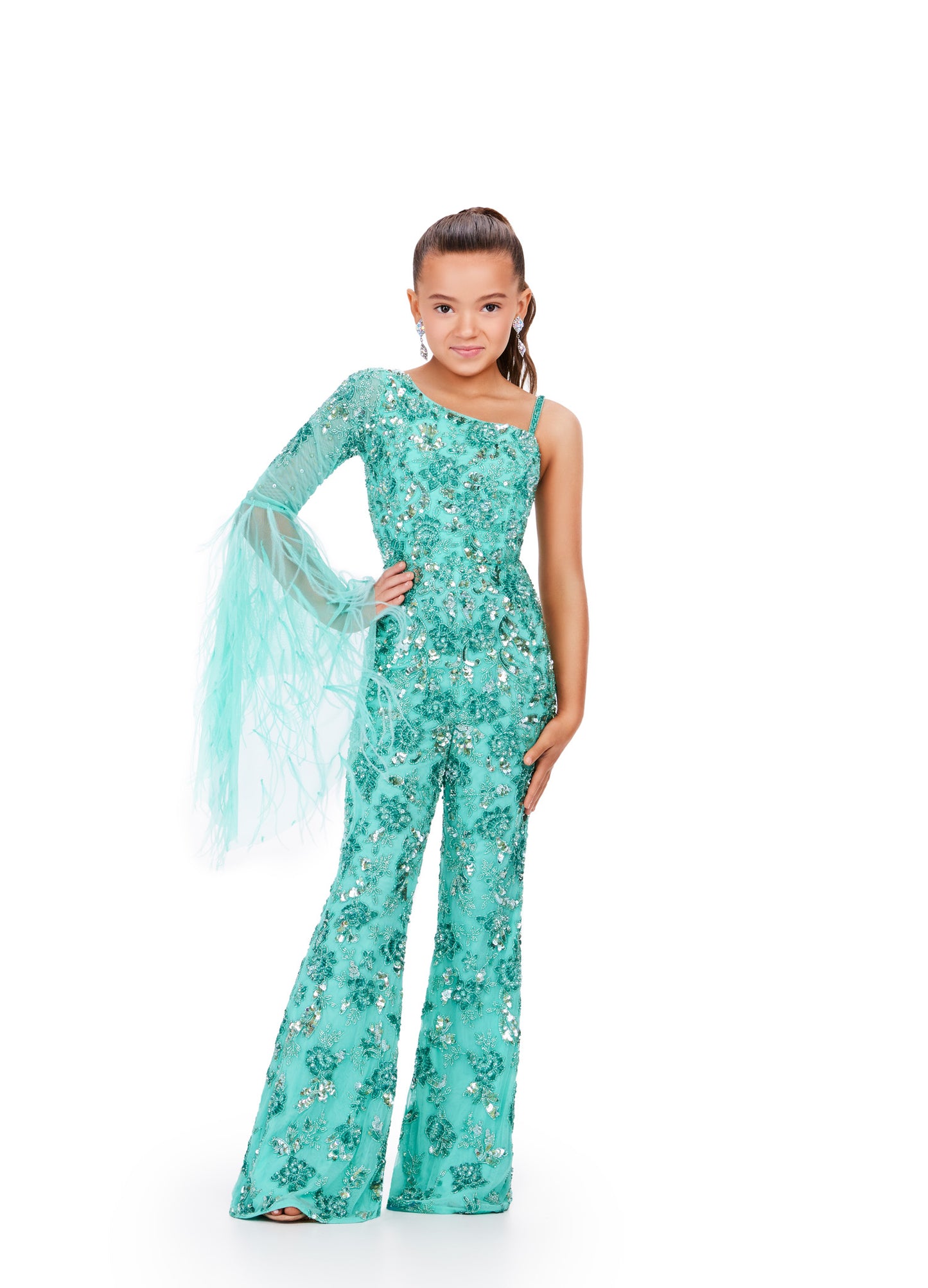 The Ashley Lauren Kids 8268 Girls Beaded Pageant Jumpsuit is a must-have for any fashion-forward young lady. Adorned with intricate beadwork and featuring dramatic feather bell sleeves, this jumpsuit will make her feel like a true fashionista. Perfect for pageants or any special occasion, it's both stylish and fun. This one shoulder kids jumpsuit features an intricate bead pattern throughout. The look is complete with a bell-sleeve scattered with feathers.