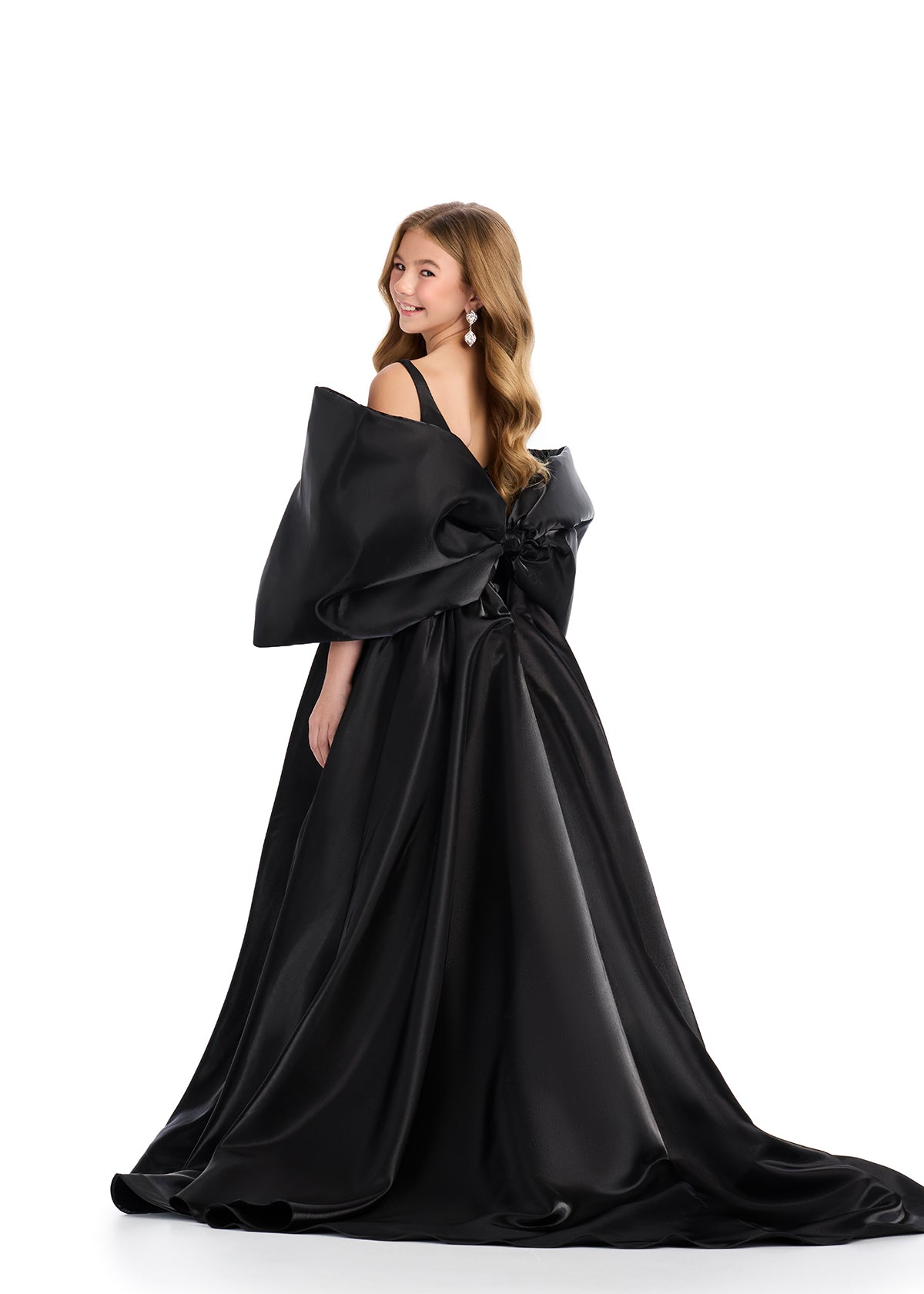 Introducing the Ashley Lauren Kids 8321 Oversize Bow Overskirt Pageant Accessory off the Shoulder Cape - the perfect addition to any pageant ensemble. The oversized bow and off the shoulder design add a touch of elegance and modernity to any outfit. Feel confident and glamorous on stage with this versatile accessory.&nbsp; Transform any outfit into a statement piece with this enchanting bow overskirt. This overskirt adds the perfect amount of glamour to any ASHLEYlauren cocktail dress, jumpsuit or dress.

B