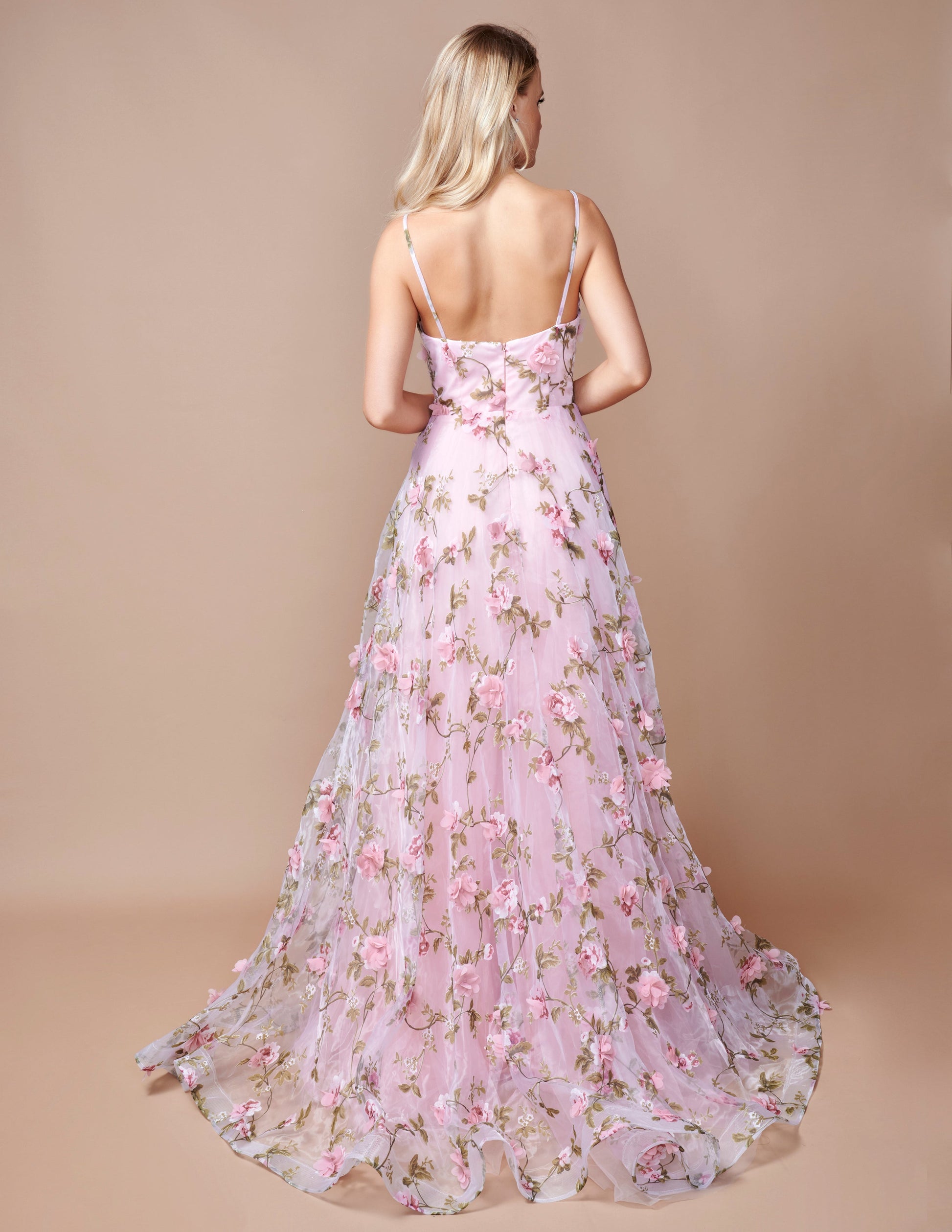 Expertly designed for a sophisticated look, the Nina Canacci 9150 Maxi Dress is the perfect choice for prom or any formal event. This stunning A-line gown features a floral print, 3D detailing, and a V-neckline that will flatter any figure. With a dramatic slit, you'll make a statement as you dance the night away.