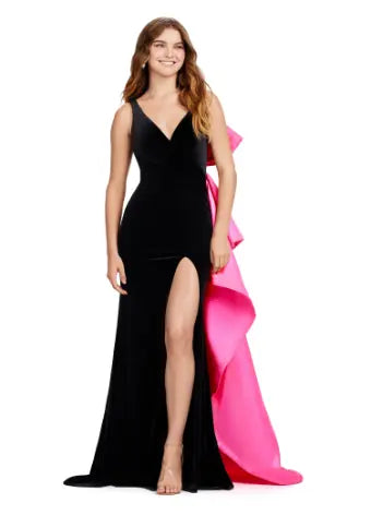 This Ashely Lauren 11527 Long Prom Dress is designed with a fitted V neckline, satin bow detailing, and a stunning open back. Its side skirt adds an elegant touch, perfect for formal events or pageants. Crafted with quality fabric, this gown exudes both style and comfort. Who doesn't love a bow moment? This v-neckline velvet gown features an inverted oversized satin bow and sweep train.