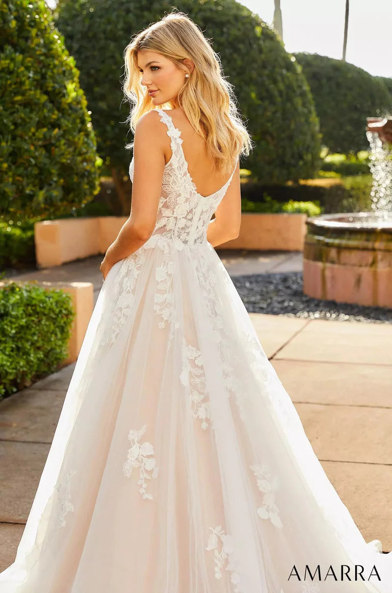 Amarra Bridal "Amanda" Ballgown Scoop Neck Sheer Floral Corset Train Wedding Gown. Look and feel like the belle of the ball in this gorgeous wedding dress. Amanda is fitted at the waist and flares out into a wide skirt, creating the look of a classic ball gown. The square neckline gives the dress tons of flair and adds a delicate, dainty touch