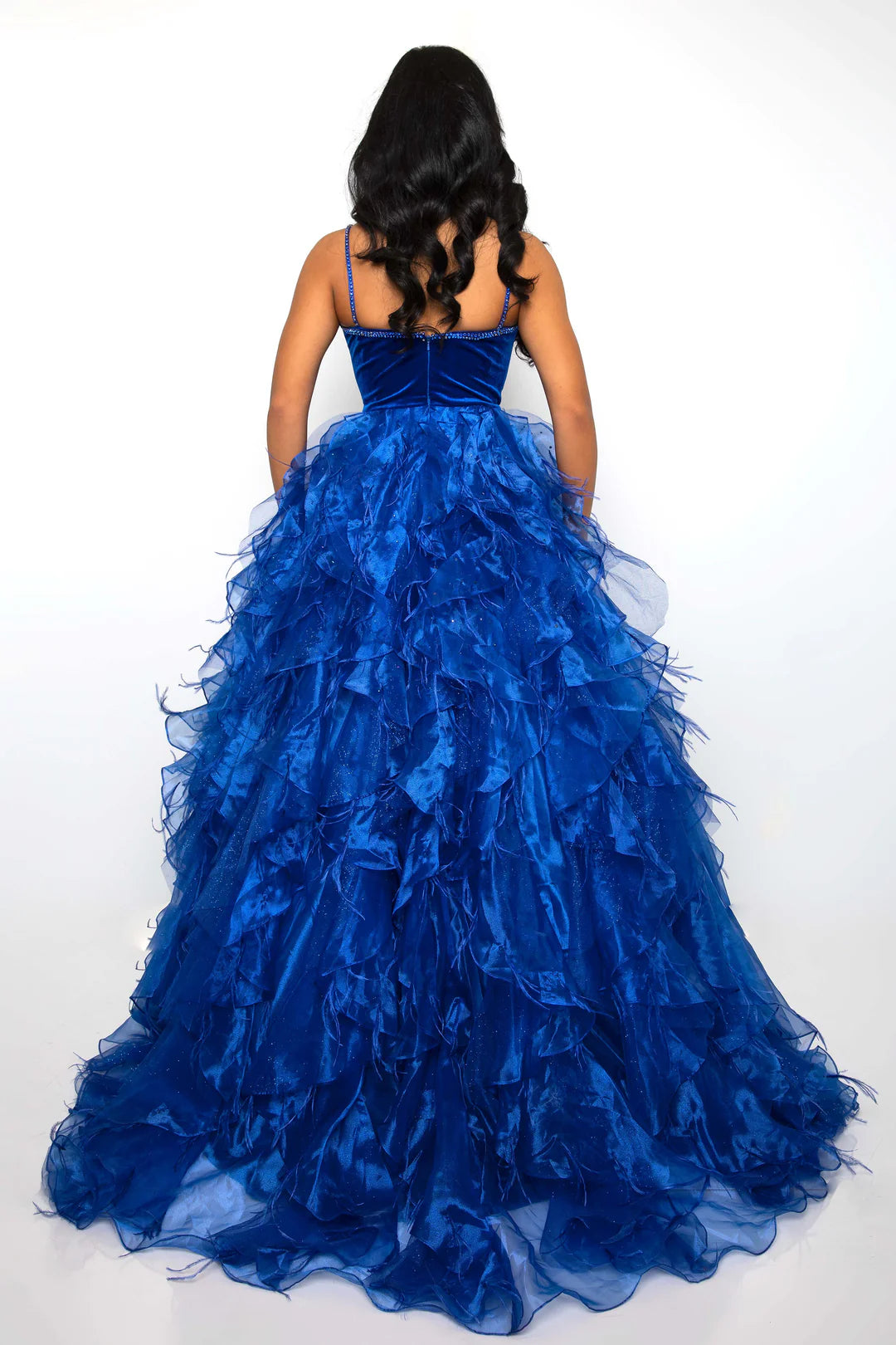 Experience glamour and sophistication in the Ava Presley 39554 Feather Velvet Dress. With its A-line silhouette, ruffle &amp; Feather ballgown with Rhinestone details, V-neckline, and luxurious velvet Bodice with Crystal accents, this dress is perfect for formal events such as pageants and prom. Get ready to turn heads and make a statement in this elegant and timeless piece.