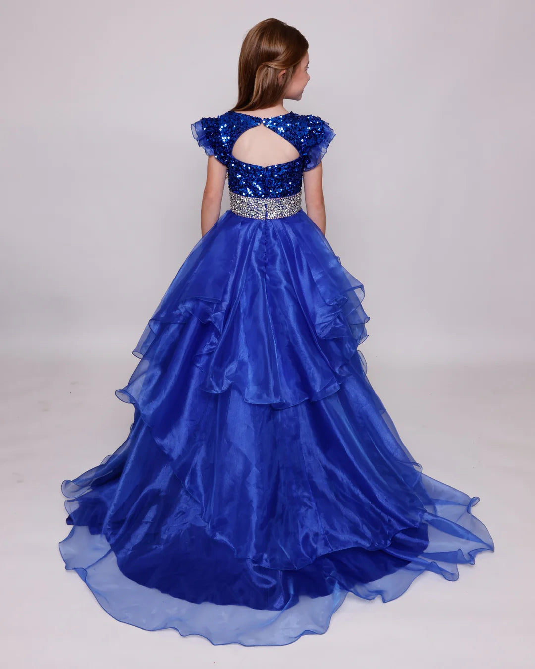 Expertly crafted and elegant, the Ava Presley 39892 girls pageant dress features a stunning blend of sequins and a keyhole ball gown train. The cap sleeves and layered design add a touch of sophistication, while the high-quality construction ensures a flawless fit for your little princess.