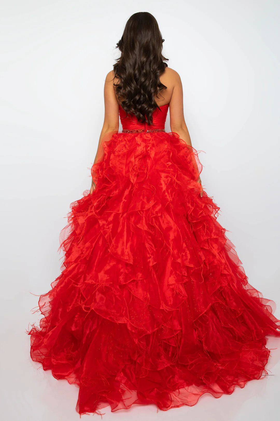 Elevate your formal attire with the Ava Presley 39555 Ballgown. This luxurious dress boasts a long feather ruffle and a strapless design, exuding elegance and style. Perfect for prom or pageants, this exclusive dress will make you feel like a true fashion icon. Float down the runway in this ethereal strapless ball gown, featuring a ruched bodice and cascading ruffle skirt that brings volume and drama. The cinched waist, adorned with a sparkling belt, adds a touch of glamour to this stunning look. Perfect fo