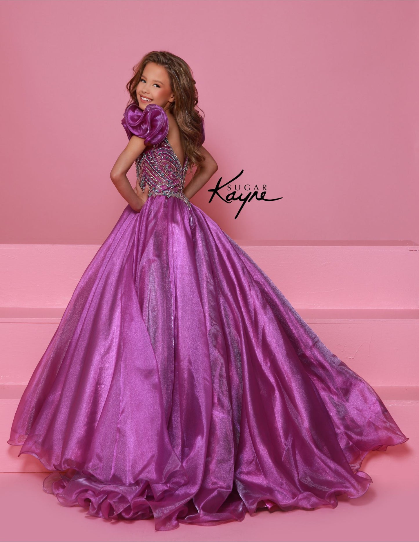 Bring out her inner beauty with this Sugar Kayne C334 Girls Pageant Dress. This luxurious dress is made from iridescent organza and features a sweetheart neckline and long ball gown skirt. Perfect for any special occasion.&nbsp;Transform into a twinkling starlet with this Metallic Organza Gown. The beaded bodice adds a touch of sparkle to this enchanting ensemble. The delicate ruffle sleeves create a charming look!

Color:&nbsp;Hot Pink Multi, Mint Multi, White Multi, Purple Multi

Size:&nbsp;2, 4, 6, 8, 10