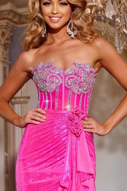 Elevate your formal attire with the Jovani D6031 Crystal Ruffle Corset Slit Prom Dress. Featuring a sweetheart neckline and intricate embellishments on the fitted bodice, this exquisite gown exudes elegance. The floor-length skirt is accented with cascading ruffles and a daring high slit for added drama. The delicate strap detailing on the open back adds a touch of allure, making this dress a must-have for any elegant occasion.