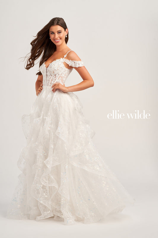 This Ellie Wilde EW35218 prom dress is a show-stopper. It features a sheer corset bodice with stone accents, lace appliques, and sequins. The detachable draped off-shoulder straps perfectly match the plunging sweetheart neckline. A-line silhouette in a long cracked ice tulle skirt adds to its timeless elegance. Make your grand entrance and shine the night away.  COLOR: BLACK, PINK, EMERALD, NAVY, WHITE