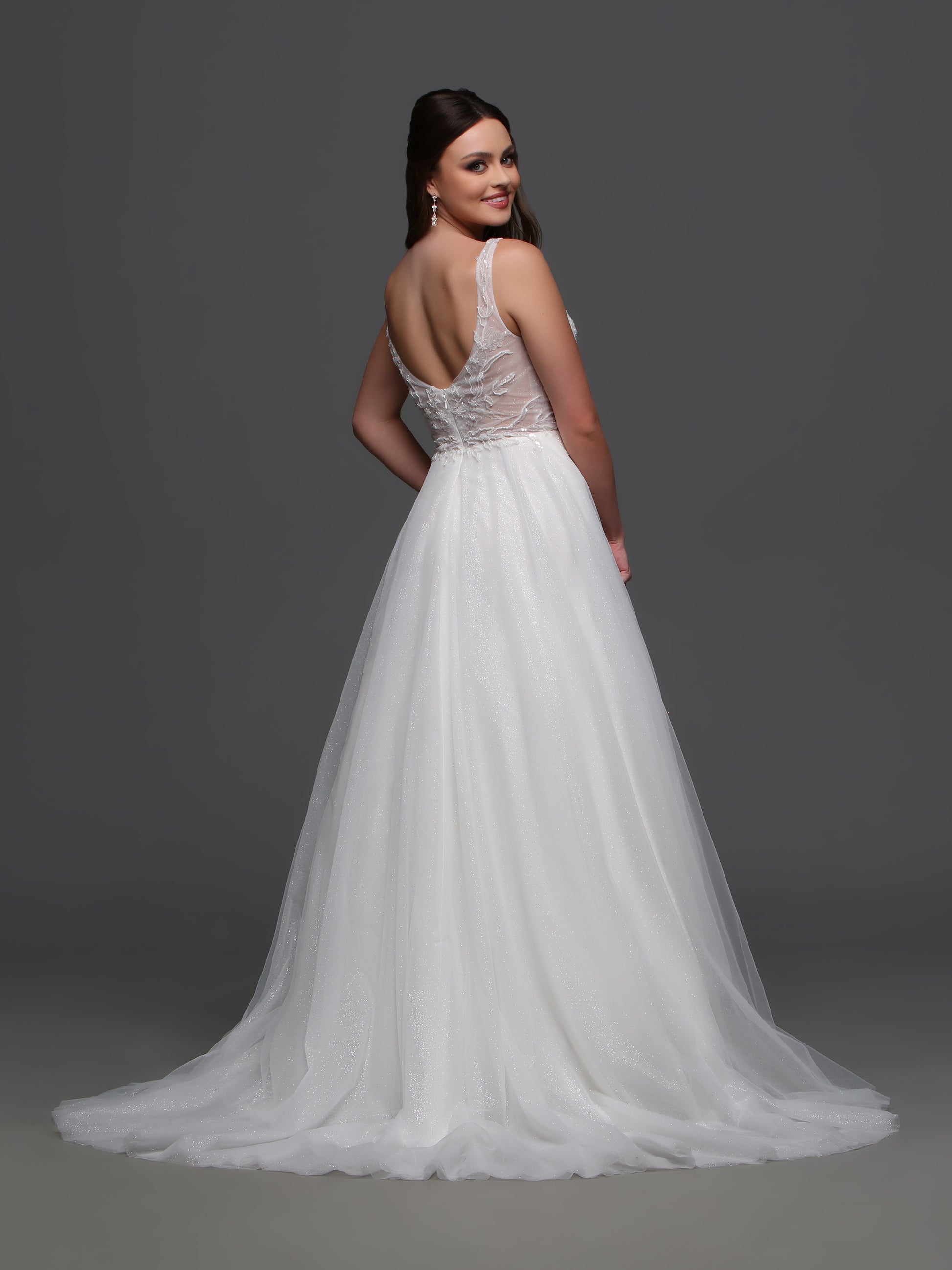 An easy-to-wear ball gown look, this wedding dress features a soft, sheer, glittering bodice and a classic fluffy tulle skirt. Indulge in luxury with the Davinci F121 A Line Shimmer Sheer Wedding Dress. Its V-neck and tulle material create an effortlessly elegant look, while the beaded bodice adds a touch of glamour. Feel like the star of your special day with this exclusive and sophisticated bridal gown.