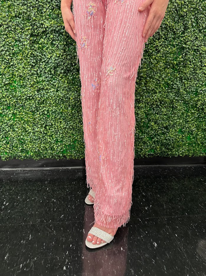 This Johnathan Kayne 31594 Jumpsuit is the perfect formalwear for special occasions. Crafted from shimmering sequin lace and delicately embellished with fringe, this size 4 pink jumpsuit is sure to turn heads.  * ONE OF A KIND  Size: 4  Color: Pink