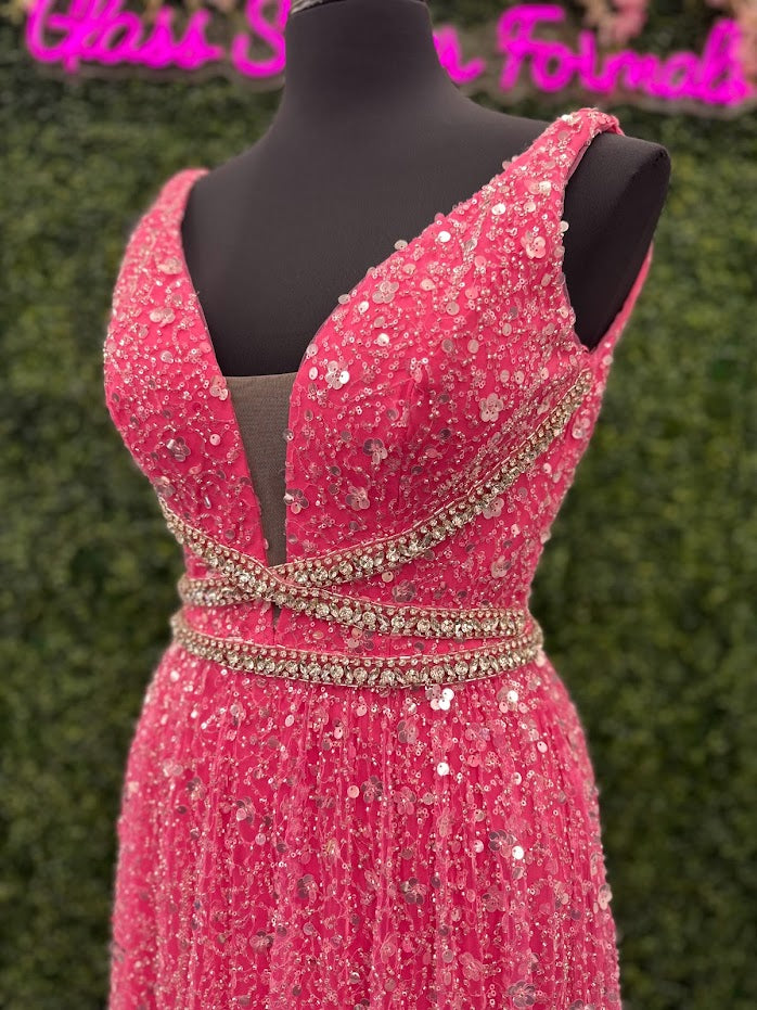 Look stunning in the Johnathan Kayne 5400 dress. This formal gown features a V-neckline, bead and sequin embellishments, and crystal accents all over for a truly show-stopping look. The A-line silhouette will flatter all body types and ensure you remain comfortable throughout the evening.  *ONE OF A KIND  Size: 4  Color: Pink