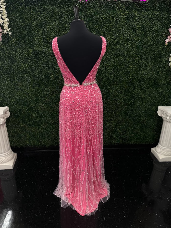 Look stunning in the Johnathan Kayne 5400 dress. This formal gown features a V-neckline, bead and sequin embellishments, and crystal accents all over for a truly show-stopping look. The A-line silhouette will flatter all body types and ensure you remain comfortable throughout the evening.  *ONE OF A KIND  Size: 4  Color: Pink