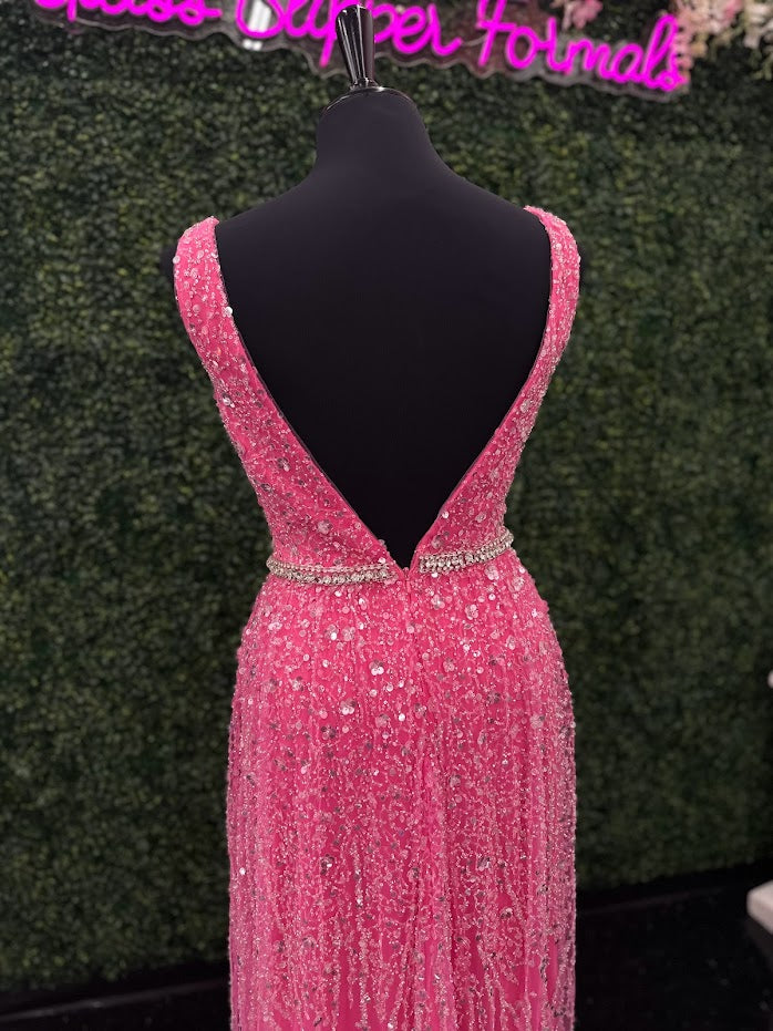 Look stunning in the Johnathan Kayne 5400 dress. This formal gown features a V-neckline, bead and sequin embellishments, and crystal accents all over for a truly show-stopping look. The A-line silhouette will flatter all body types and ensure you remain comfortable throughout the evening.  *ONE OF A KIND  Size: 4  Color: Pink