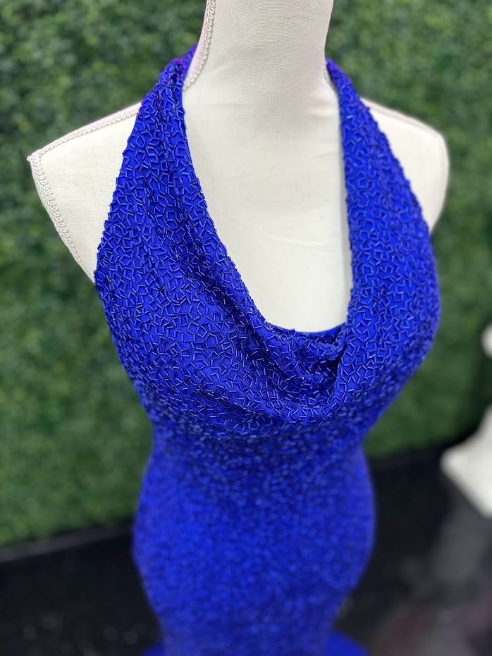 Johnathan Kayne 2728 is a size 4 cowl neck formal gown crafted with Custom Liquid Beading. The halter neck closure makes for a beautiful and stylish silhouette with a royal finish. Perfect for your next event!   ** One of a kind Custom  Size: 4  Color: Royal