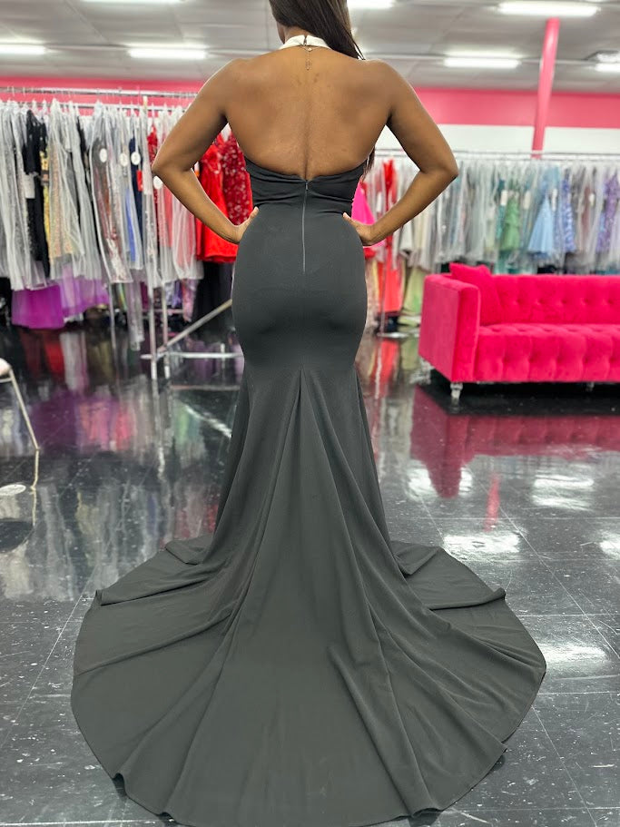 Elevate your evening attire with the Johnathan Kayne 1442 Size 4 Black Long Tuxedo Dress. This classy gown features a sleek tuxedo design, perfect for formal events or pageants. Its black color adds a touch of elegance, while the long length provides a sophisticated silhouette. Stand out from the crowd in style and confidence.