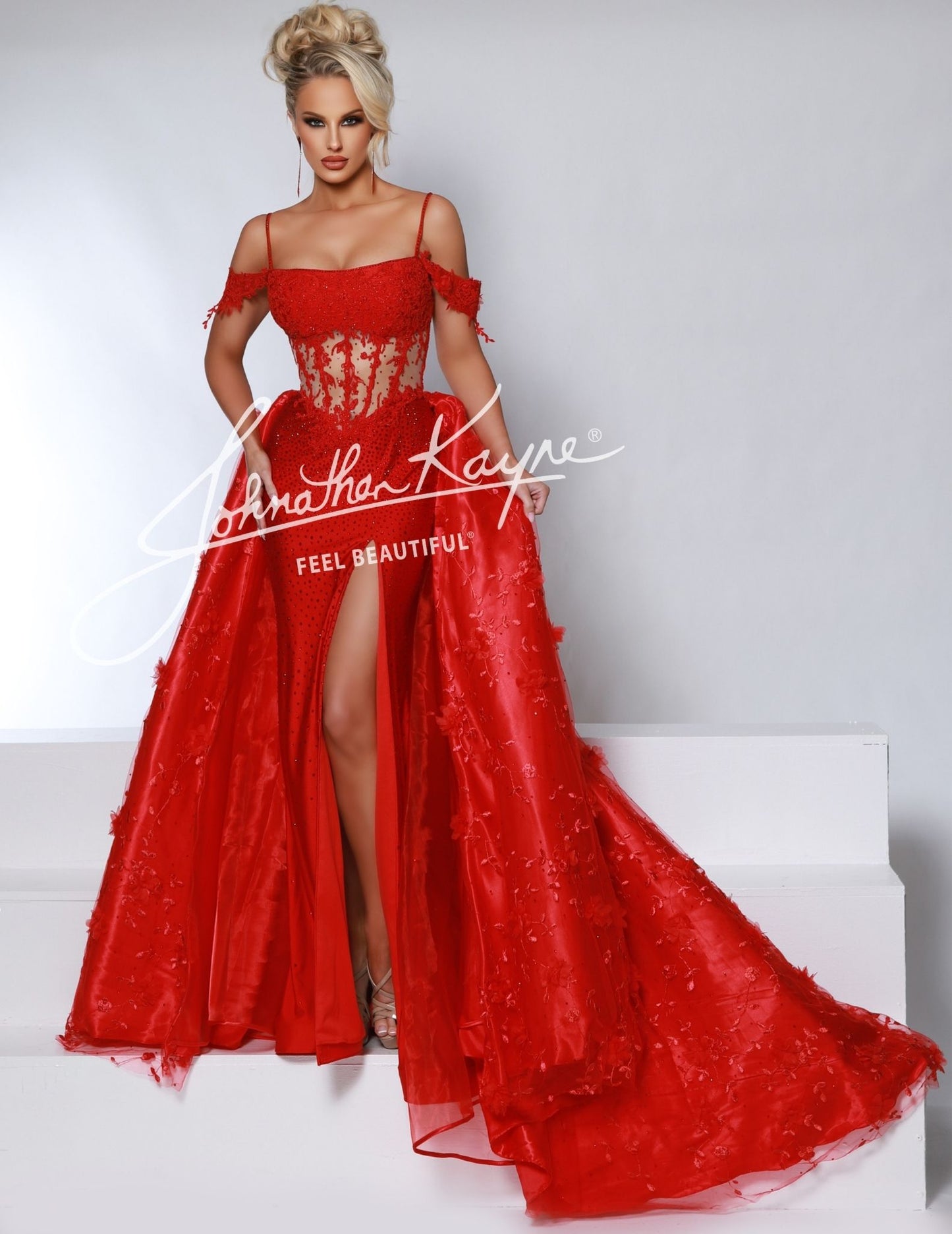 Experience elegance and sophistication with the Johnathan Kayne 2965 dress. The fitted lace silhouette is complemented by a sheer corset and off-the-shoulder design, creating a sleek and sexy look. With a dramatic overskirt and daring thigh-high slit, this dress is perfect for pageants and formal occasions. 