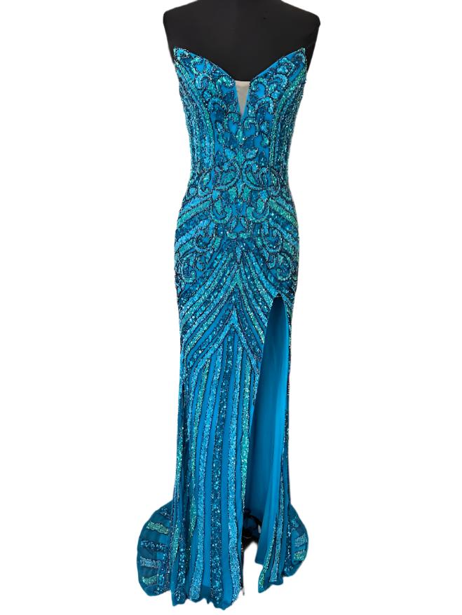 The Jovani 38707 prom dress is a stunning and sophisticated gown designed for formal occasions, making it a perfect choice for prom. This floor-length dress is made from delicate mesh fabric, which gives it a lightweight and semi-transparent quality, adding a touch of elegance to the overall look.