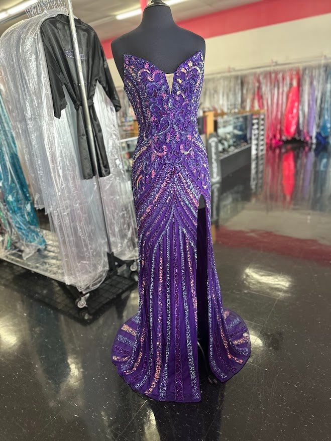 The Jovani 38707 prom dress is a stunning and sophisticated gown designed for formal occasions, making it a perfect choice for prom. This floor-length dress is made from delicate mesh fabric, which gives it a lightweight and semi-transparent quality, adding a touch of elegance to the overall look.