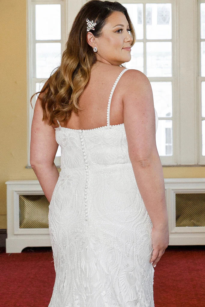 Michelle Bridal For Sydney's Closet MB2314 Slim Silhouette Crochet Lace Bridal Tulle V-Neck Optional Modesty Panelt Plus Size "Maya" Bridal Gown. The Michelle Bridal for Sydney's Closet MB2314 gown is the perfect choice for the modern bride. This slim silhouette gown is crafted with intricate crochet lace and soft tulle, and features an optional modesty panel for added coverage. The V-neckline flatters the figure, while the plus size construction ensures a perfect fit. This dress exudes luxury,