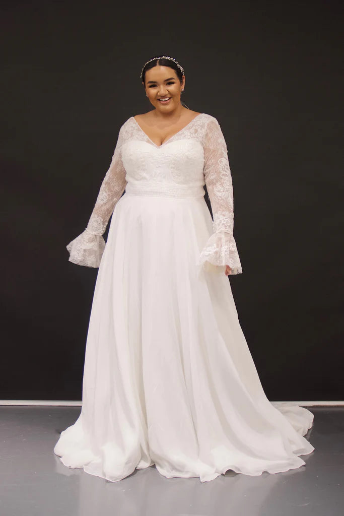 Michelle Bridal For Sydney's Closet MB2319 A-Line Lace Chiffon Net Long Sleeves With Detachable Cuff V-Bodice Plus Size "Hedy" Bridal Gown. Michelle Bridal's MB2319 A-Line "Hedy" Bridal Gown provides a timeless silhouette with luxurious detailing. Features include a lace chiffon net material, V-bodice, plus size, and detachable cuffs for a look of sophistication and elegance. Perfect for any marriage celebration, this gown is sure to impress.