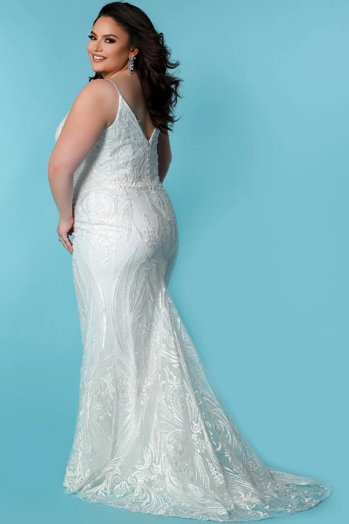 Sydneys Coset SC5287 Jolene Plus Size Bridal Dress. The Sydneys Coset SC5287 Jolene Plus Size Bridal Dress features an opulent, intricate bodice and cascading layers of matte chiffon on the skirt. Its timeless silhouette is cut to flatter the female form, and create an elegant statement as you take your place at the altar. This exquisite dress is designed exclusively for the plus size bride and is sure to make a lasting impression on your special day.