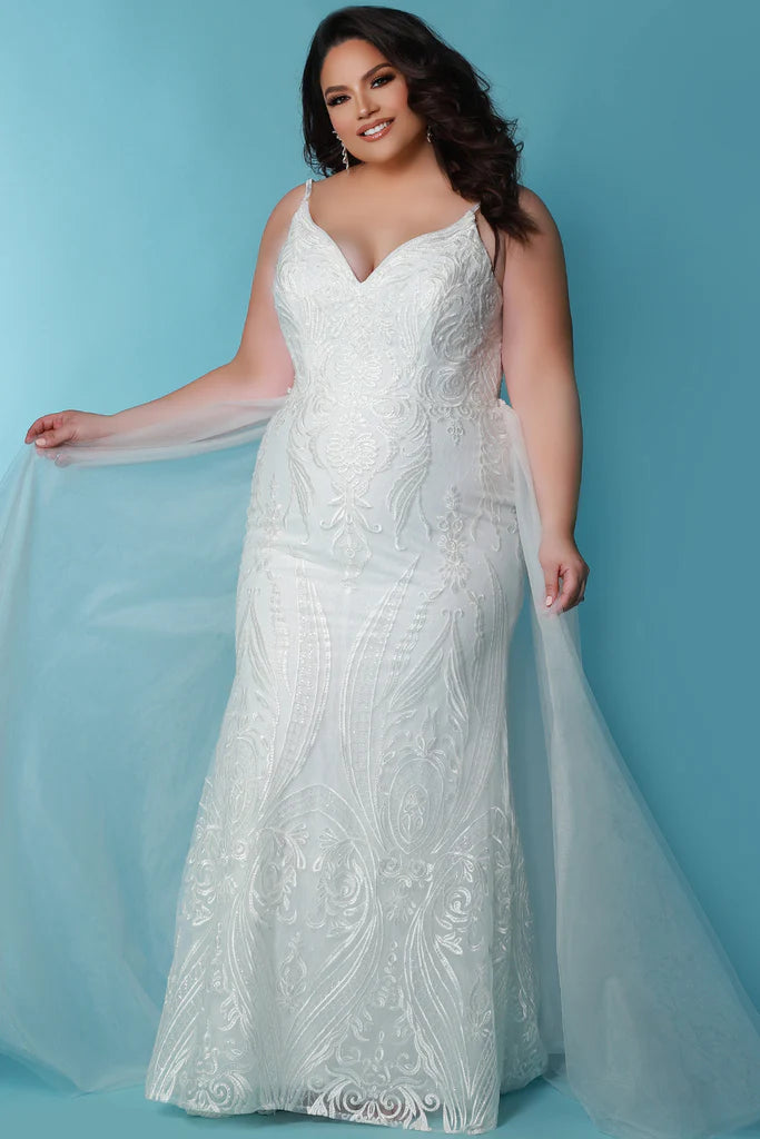 Sydneys Coset SC5287 Jolene Plus Size Bridal Dress. The Sydneys Coset SC5287 Jolene Plus Size Bridal Dress features an opulent, intricate bodice and cascading layers of matte chiffon on the skirt. Its timeless silhouette is cut to flatter the female form, and create an elegant statement as you take your place at the altar. This exquisite dress is designed exclusively for the plus size bride and is sure to make a lasting impression on your special day.