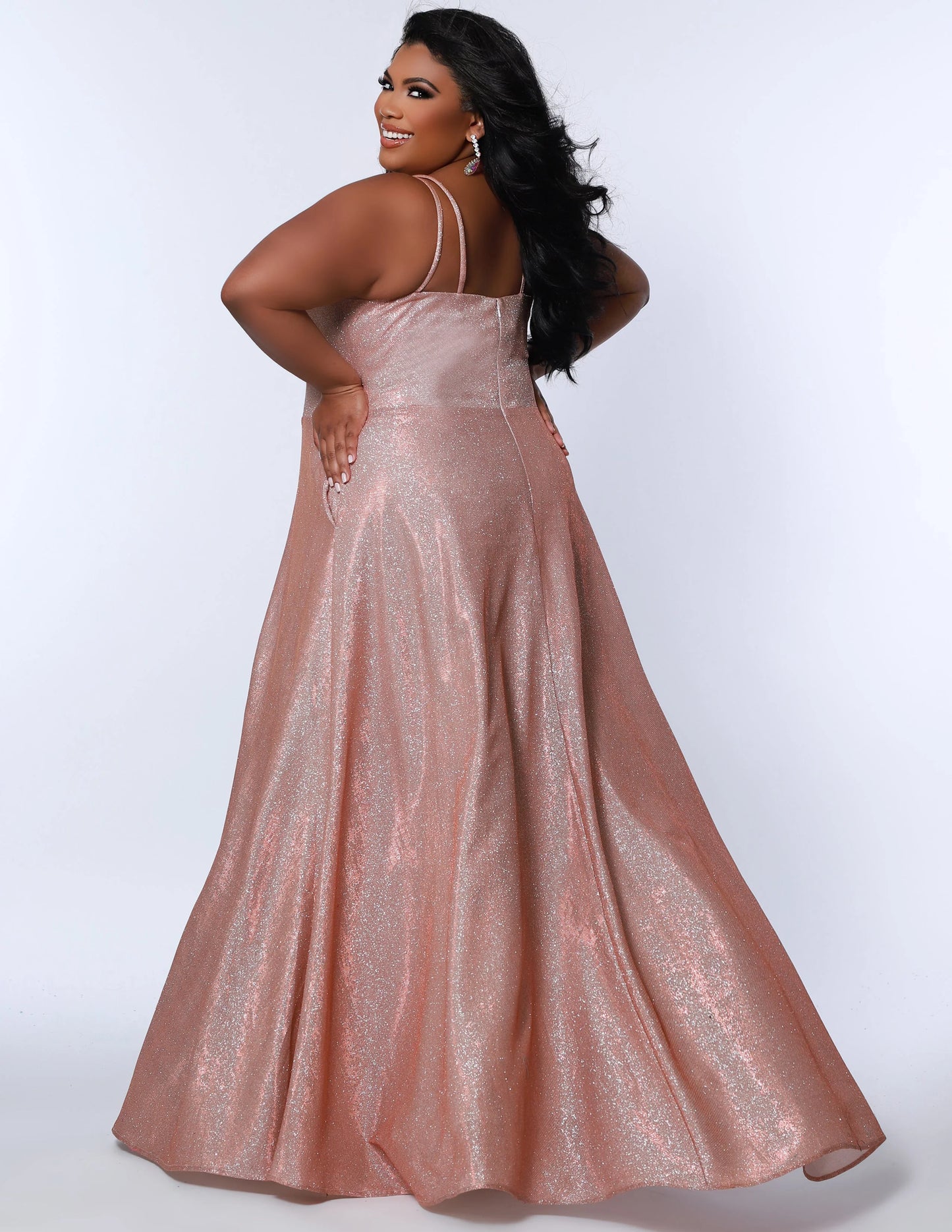 This plus-sized prom dress from Sydney's Closet SC7349 is made of shimmering knit and features an A-line silhouette, scoop neckline, double straps, zip-up back, natural waist, A-line skirt with slit, and hidden pockets. Fully lined for a comfortable and flattering fit. Perfect for special occasions. Keep it sweet and sparkly when you wear our classic A-line plus size prom dress! 