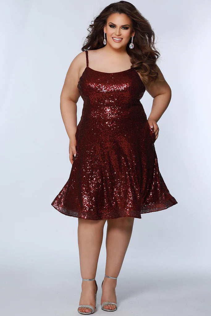 Sydney's Closet SC8122 A-Line Multi-Dimensional Sequins Scoop Neck With Pockets Short Plus Size Homecoming Dress. Make your homecoming night unforgettable with this plus size showstopper! Sydney's Closet SC8122 dress features a dazzling multi-dimensional sequin exterior, scoop neckline, and front pockets to keep your dancing essentials close at hand. A glam-slam pick that will leave you feeling your 'prom