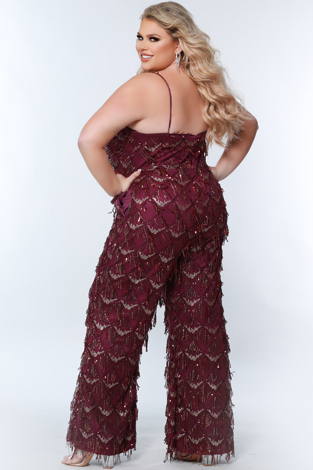 Sydney's Closet SC9108 Long Plus Size Sequin Fringe Jumpsuit Formal Pockets V Neck  Color: Diamond White, Navy, Sangria Size: 14-28 Sequin fringe Jumpsuit Spaghetti straps covered in sequins V-neckline Pockets Natural waistline Wide leg pant