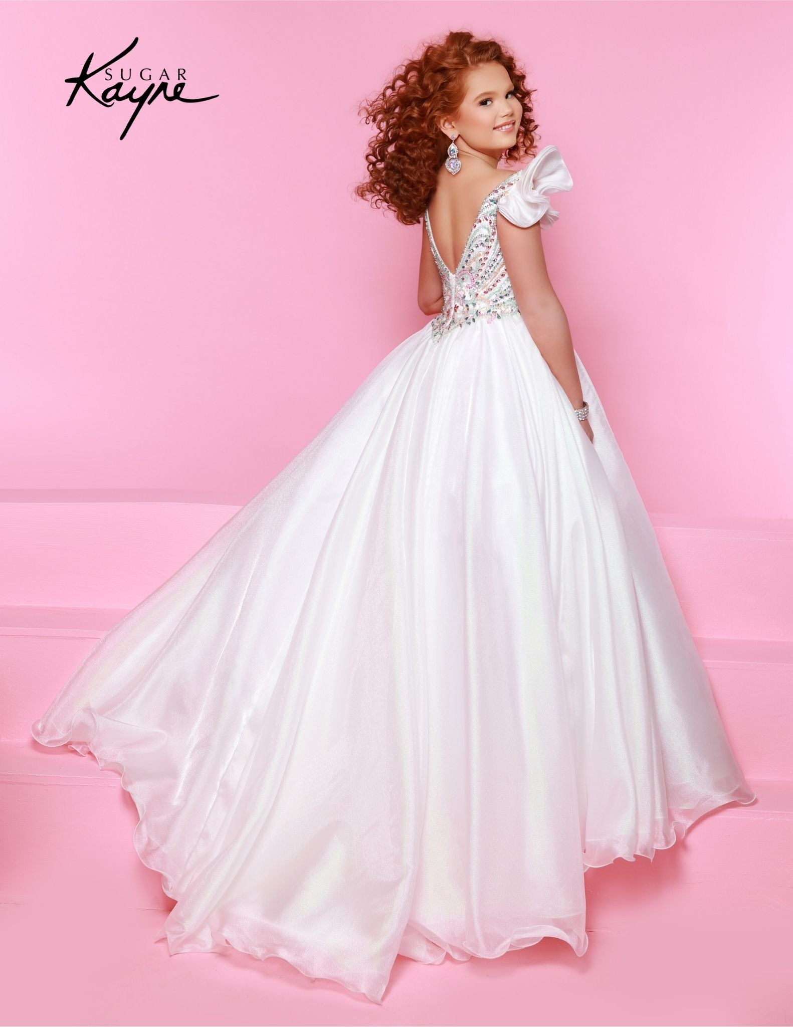 Bring out her inner beauty with this Sugar Kayne C334 Girls Pageant Dress. This luxurious dress is made from iridescent organza and features a sweetheart neckline and long ball gown skirt. Perfect for any special occasion. Transform into a twinkling starlet with this Metallic Organza Gown. The beaded bodice adds a touch of sparkle to this enchanting ensemble. The delicate ruffle sleeves create a charming look!