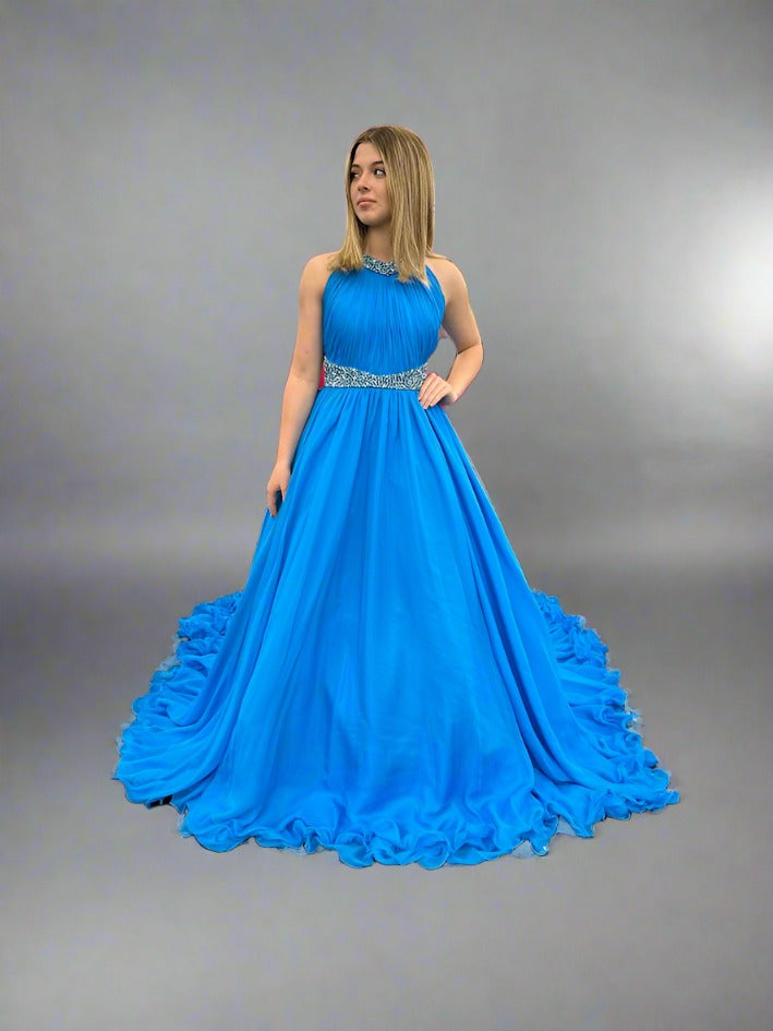 Samantha Blake 1102 Girls Pageant Dress. This stunning A Line Chiffon gown, complete with a detachable crystal Embellished cape and chiffon material, will make any young girl feel like a princess. With its train design, it offers elegance and grace for any special occasion. Get yours today and make a statement at your next Pageant.