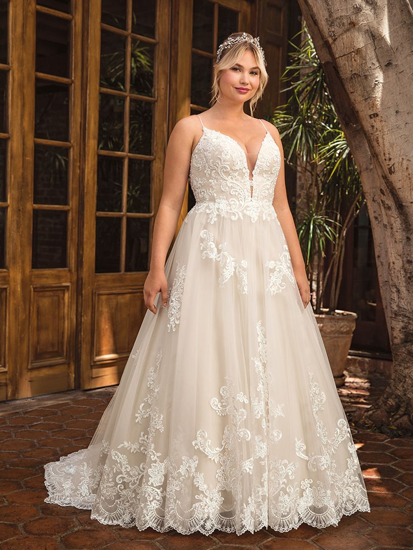 Casablanca Beloved STYLE BL286 DELILAH Other-worldly grace surrounds Delilah, swimming in sateen satin and tulle. Lace appliques cover the bodice and cascade down the flowing skirt of this bohemian wedding gown from Beloved by Casablanca Bridal. Spaghetti straps and a plunging neckline add a seductive touch, transitioning into an alluring illusion lace back. Subtle silver beading catches the light, while a matching veil finishes off this modern boho gown with a glimmer!