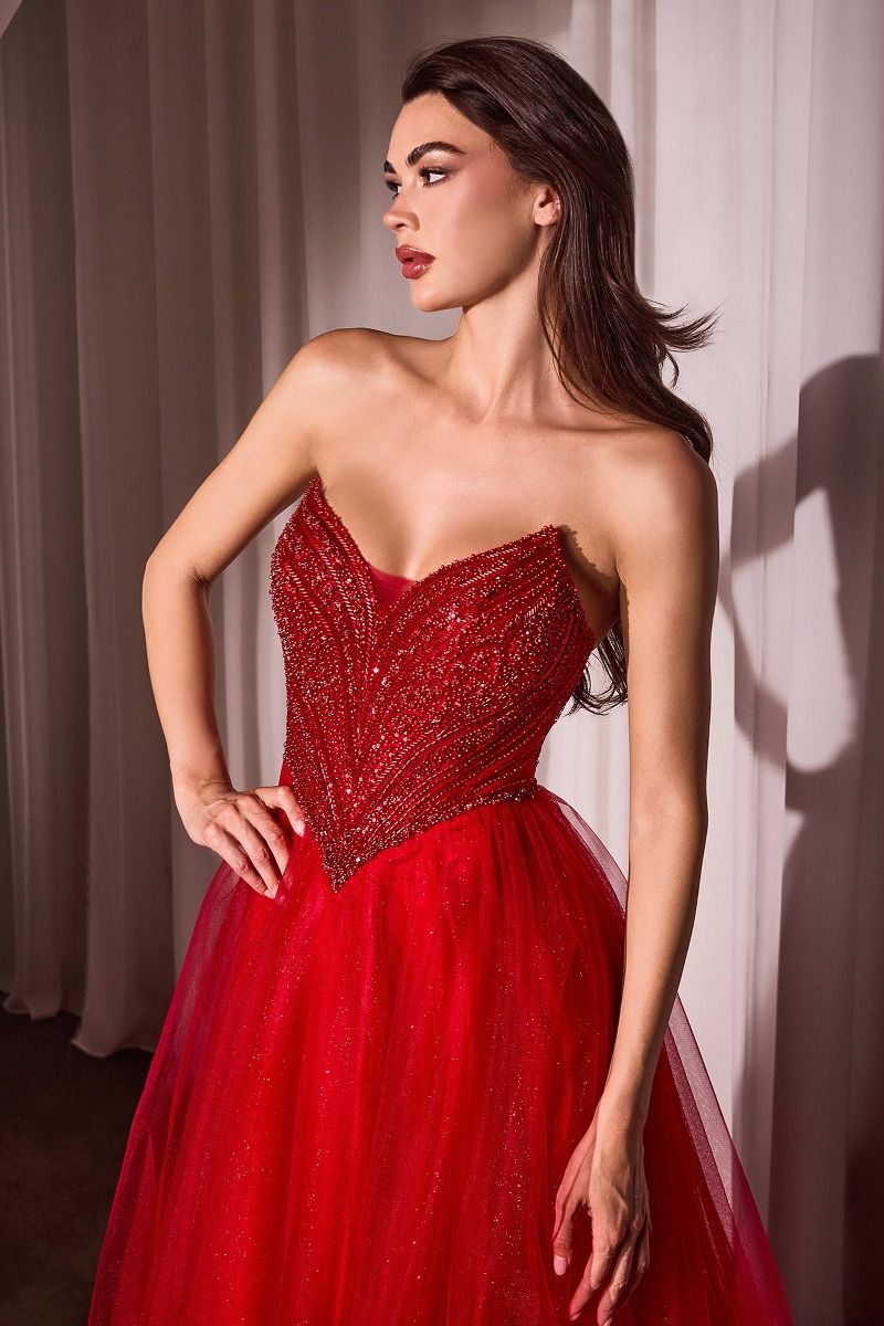 Elevate your prom look with the Ladivine CC415 V Neck Corset Prom Dress. This stunning gown features a beaded bodice and shimmering A Line skirt for a touch of glamour. The sheer neckline and corset back add a hint of sexy to this classic ballgown. Perfect for a formal occasion. Step into the spotlight in this enchanting A-line dress, featuring a pointed strapless neckline and exquisite beaded details that catch the light beautifully. The fitted bodice with a princess waistline accentuates your figure, whil