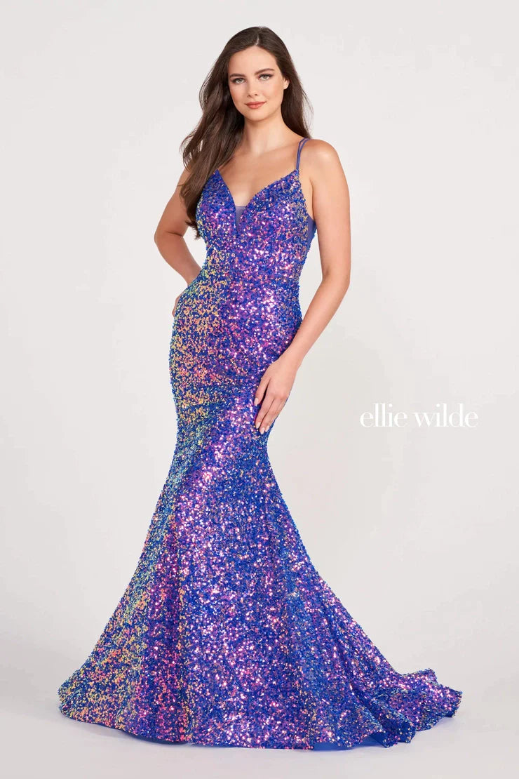 Look sophisticated and graceful in Ellie Wilde EW34016. The signature Iridescent color shifting sequins and mermaid silhouette make this timeless corset dress a perfect choice for a formal occasion. Captivate everyone in the room with its sparkling iridescent material and backless v-neckline.  Sizes: 8  Colors: IRIS  https://dy9ihb9itgy3g.cloudfront.net/static/themes/EllieWilde/Spring_2023/EW34016.mp4