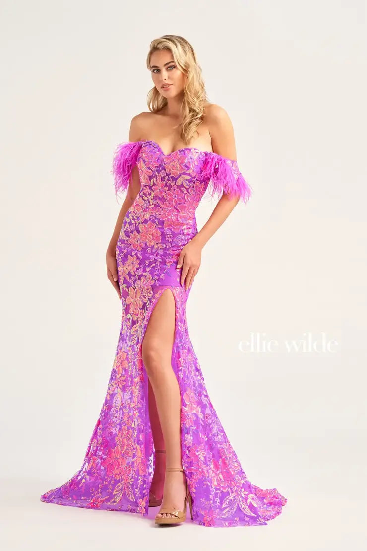 The Ellie Wilde EW34034 is a glamorous formal gown featuring an off-the-shoulder neckline, corset bodice, and a full-length sheer sequin skirt with a side slit. Festooned with a beautiful feather trim, this dress is sure to make a statement.  Sizes: 00-16  Colors: ORANGE, ROYAL BLUE, LILAC, HOT PINK, SAPPHIRE, SKY BLUE, EMERALD, PURPLE RAIN