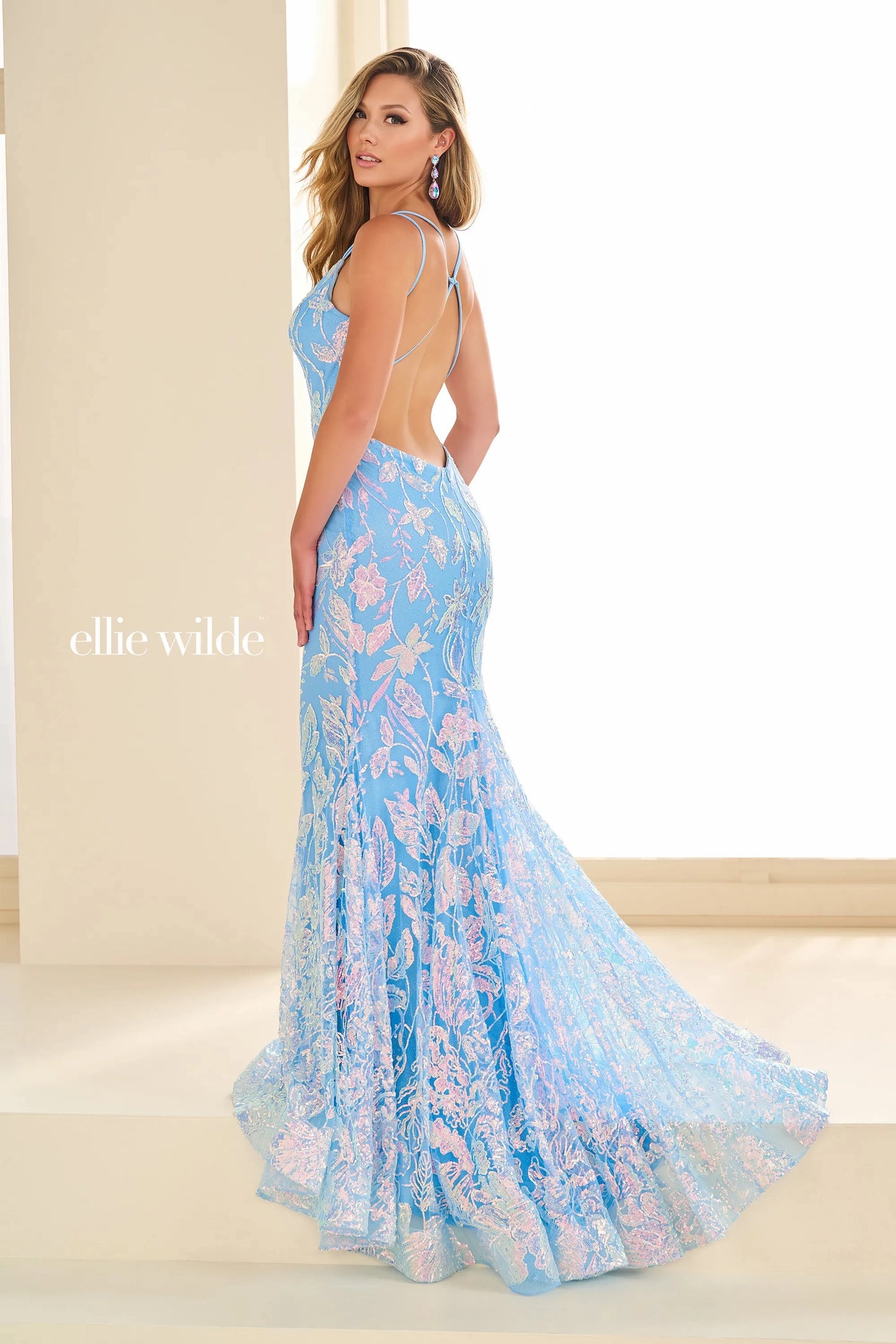 Expertly designed by Ellie Wilde EW36034 this long backless mermaid prom dress is a show-stopping piece. With its shimmering sequins and figure-flattering silhouette, this gown will make you feel like the belle of the ball. Perfect for pageants, prom, or any special occasion, this dress is sure to turn heads.