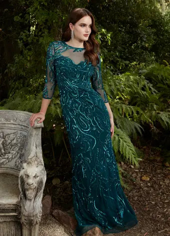 Ashley Lauren 11208 Three Quarter Sleeve Beaded Crew Neckline High Illusion Back Fully Hand Beaded Evening Gown. This gorgeous evening gown has a crew neckline, fitted mesh sleeves and a modern, intricate bead batter throughout. It is perfect for your next event.