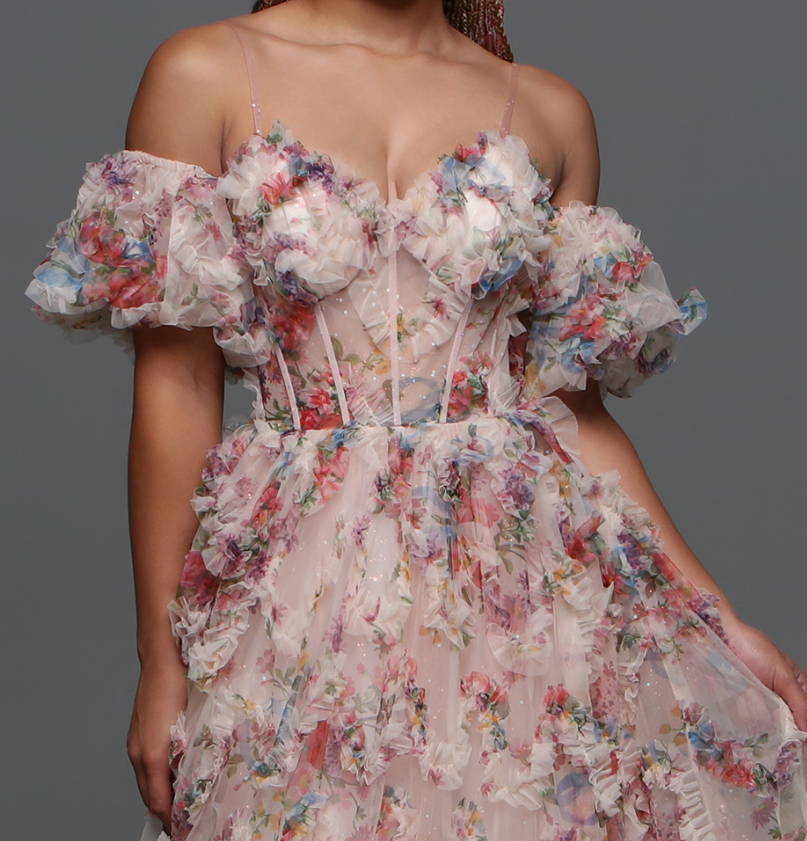 Experience elegance and grace with the Davinci F145 Floral Print Prom Dress. The stunning puff sleeves and A-line silhouette enhance your natural beauty while the sheer corset and shimmering pleats create a dreamy and ethereal look.