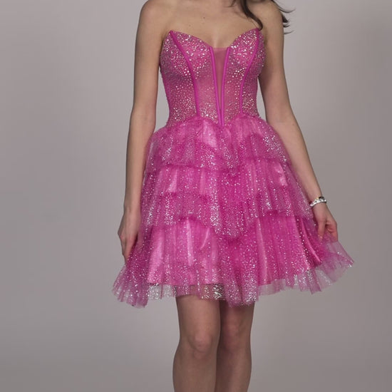 Get ready to sparkle in this Short Glitter Layer Sheer Corset Homecoming Dress by Dave &amp; Johnny. Designed with a flattering A Line cut, this cocktail gown is perfect for any special occasion. The glitter overlay adds a touch of glamour, while the sheer corset provides a sexy and unique detail. Channel your inner fashionista with this stunning dress.