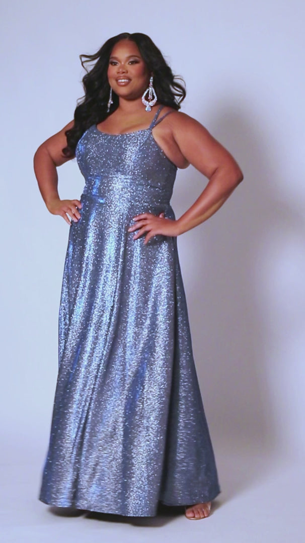 This plus-sized prom dress from Sydney's Closet SC7349 is made of shimmering knit and features an A-line silhouette, scoop neckline, double straps, zip-up back, natural waist, A-line skirt with slit, and hidden pockets. Fully lined for a comfortable and flattering fit. Perfect for special occasions. Keep it sweet and sparkly when you wear our classic A-line plus size prom dress! 