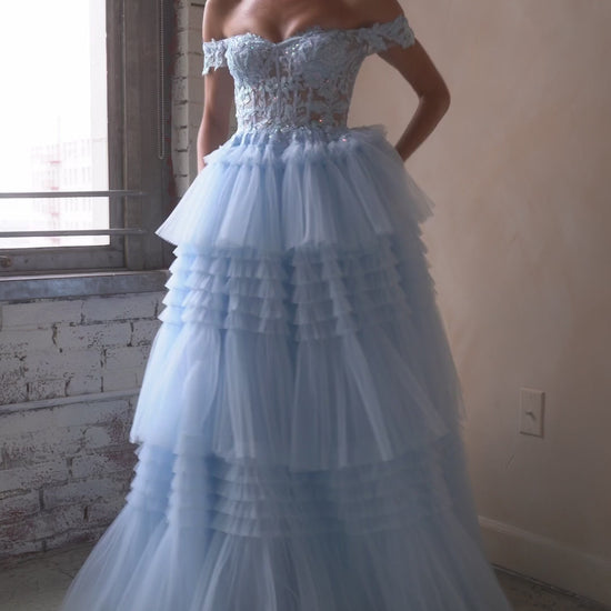 Indulge in the opulence of Ladivine's 9315 Long Layered Tulle Ballgown. The stunning sheer lace corset and off-the-shoulder design exude elegance, while the layered tulle adds volume and movement. Perfect for prom or any formal event, this dress will make you feel like a princess. Let your fairytale dreams come true with this exquisite layered pleated tulle ball gown!