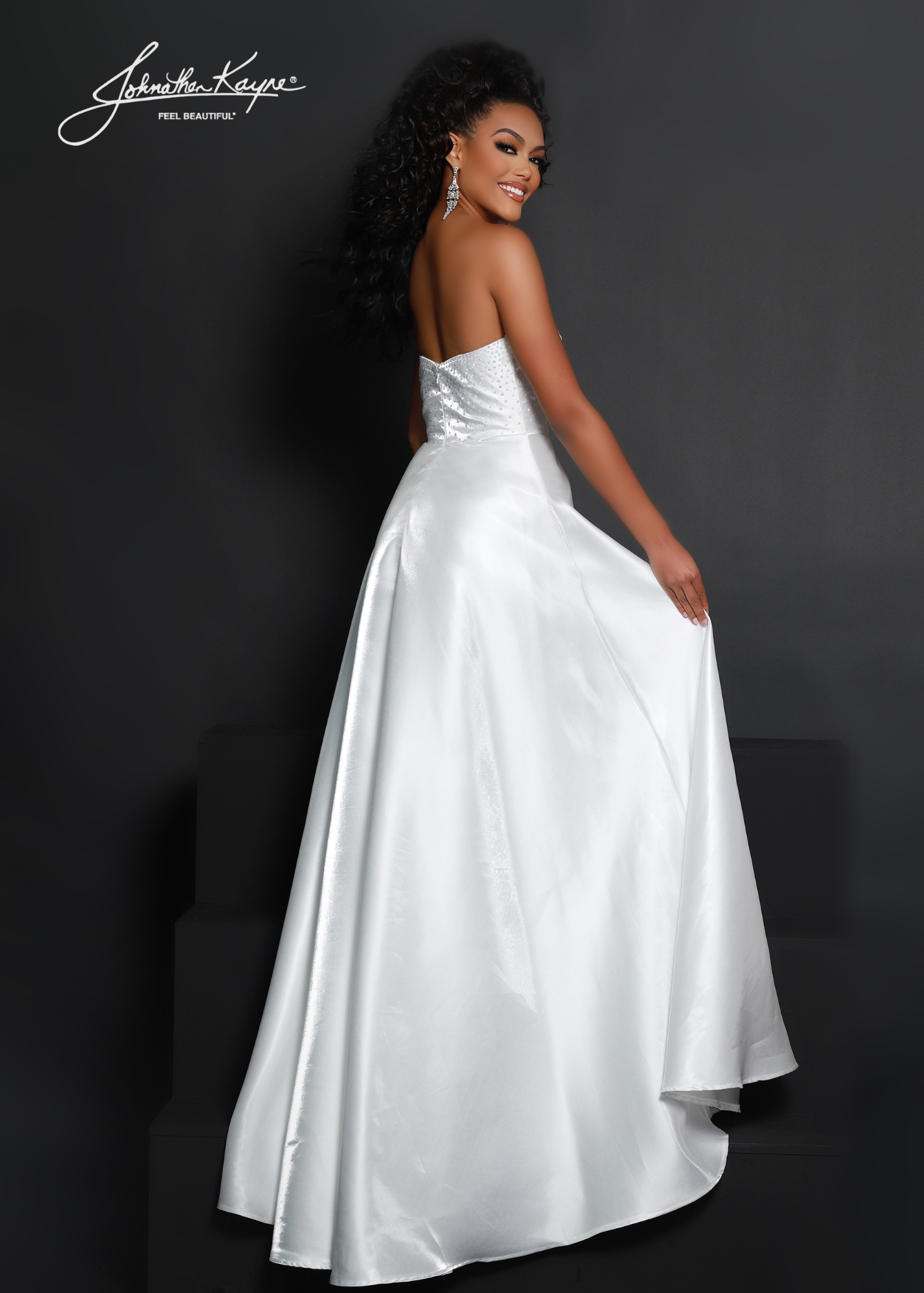 Make a statement in this Johnathan Kayne 2642 dress! Made of luxurious White Shimmer satin, its A-line silhouette and puff sleeves will have you looking fabulous for any formal occasion. With a high slit for extra pizzazz, you won't be able to resist this elegant maxi dress! Shake things up in style! Show off your style and sophistication in this beautiful shimmer satin A-line gown with removeable puff sleeves at any event  Size: 2  Color: White