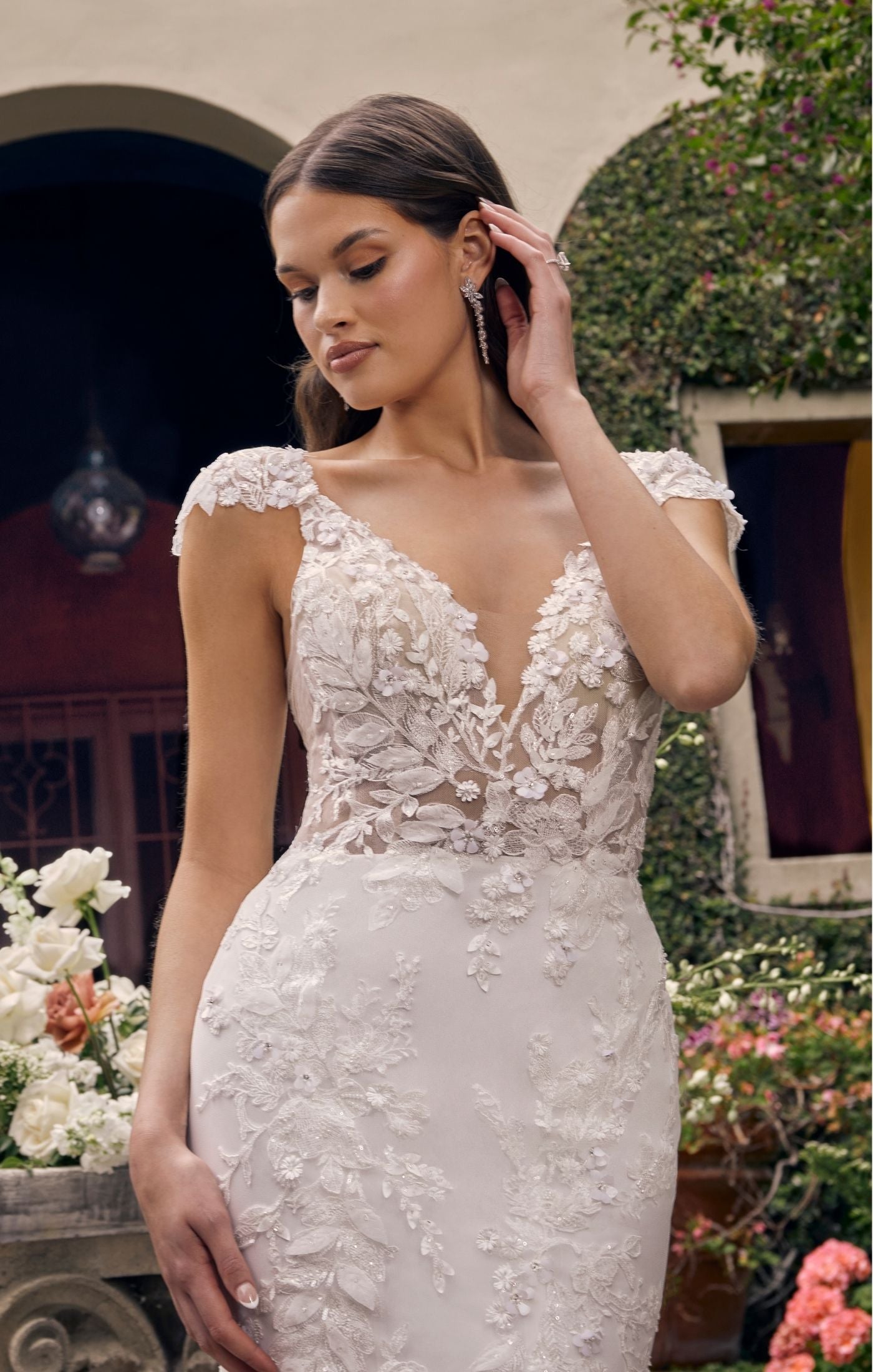 Casablanca Bridal 2543 Delphine Fitted 3D Floral Lace Deep V-Neck Detachable Cap Sleeves Train Wedding Gown. Featuring lovely beading and sequins, all over 3D floral lace throughout the gown adds soft dimension to her look. The sheer bodice is given a subtle plunge at the V-neckline that is perfectly accented with beaded spaghetti straps and detachable cap sleeves (included). The fitted silhouette, paired with a stretchy chiffon lining, will hug and contour your curves.