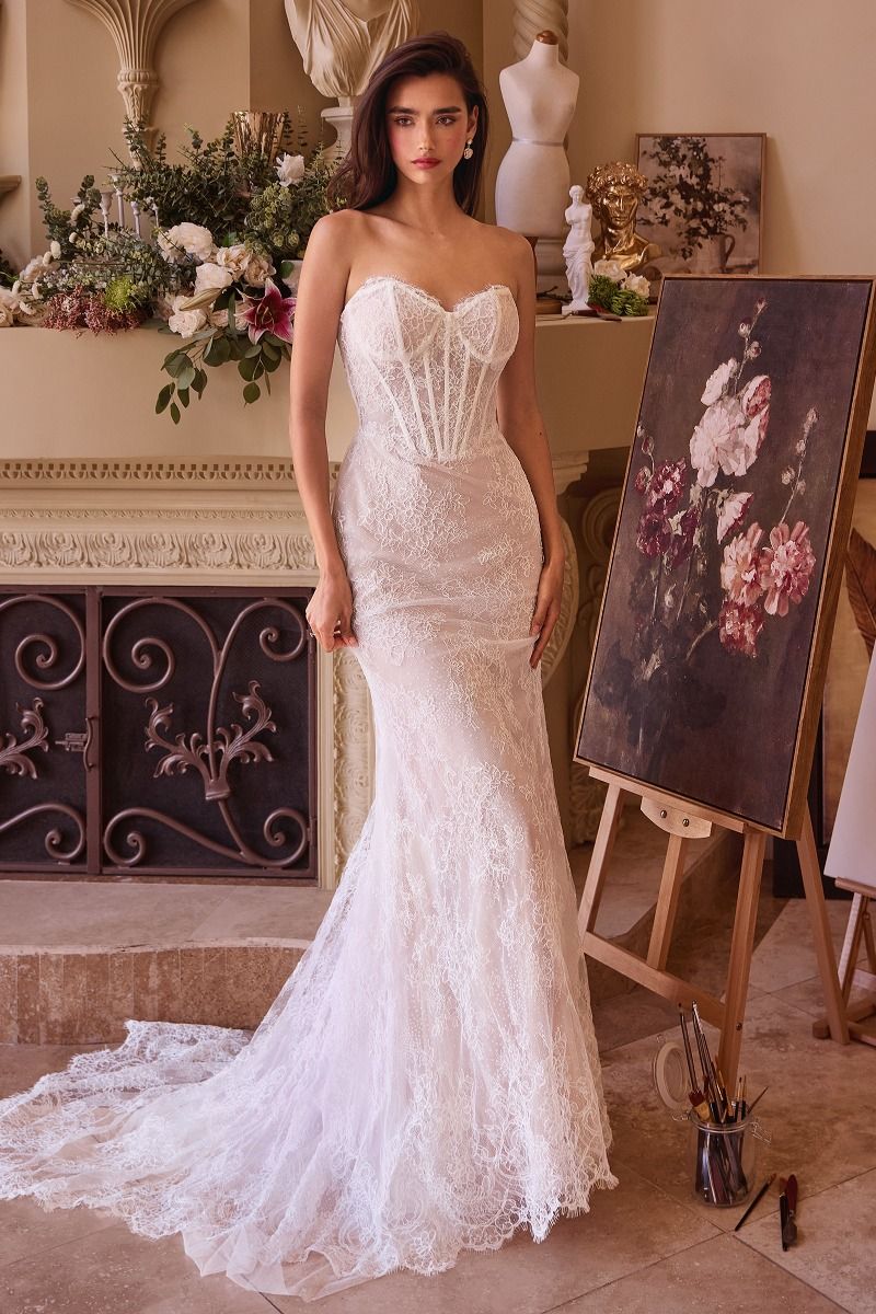 Elevate your wedding day style with the Ladivine WL044 Lace Corset Mermaid Wedding Dress. Featuring a delicate lace corset, this gown hugs your curves for a flattering fit. The overskirt adds a touch of drama and elegance, perfect for making a statement as you walk down the aisle. Complete with a strapless design and stunning train, this dress is the perfect choice for the modern bride. Embrace your elegance in this fitted wedding dress featuring a strapless sweetheart neckline and a sheer bodice, beautiful