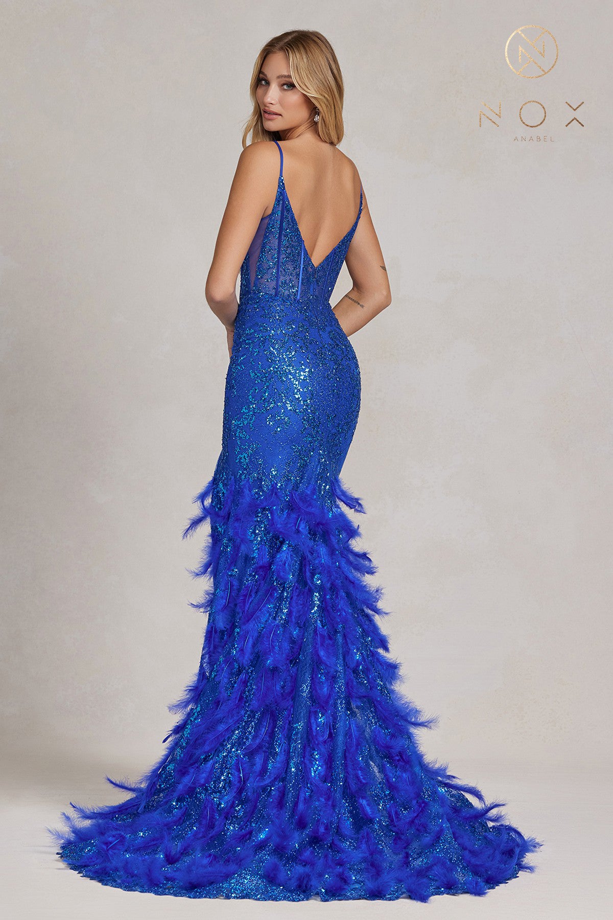 Nox Anabel C1119 Long Sheer Fitted Corset bodice with a v neckline Feather & Sequin embellished Mermaid skirt with a slit Prom Dress Pageant Gown.  Sizes: 00-16  Colors: Black, Emerald, Fuchsia, Royal Blue, Red