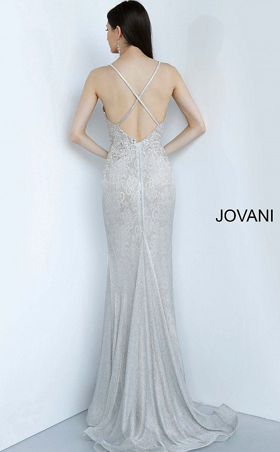 Jovani 03167 is a 2021 Prom Dress, Pageant Gown & Formal Evening Wear.  Details: Silver lace dress, fully lined, form fitting silhouette, floor length, embellished Spaghetti strap bodice, plunging neckline with mesh insert for support, open back with embellished criss cross straps. Available Sizes: 00,0,2,4,6,8,10,12,14,16,18,20,22,24 Available Colors: Silver