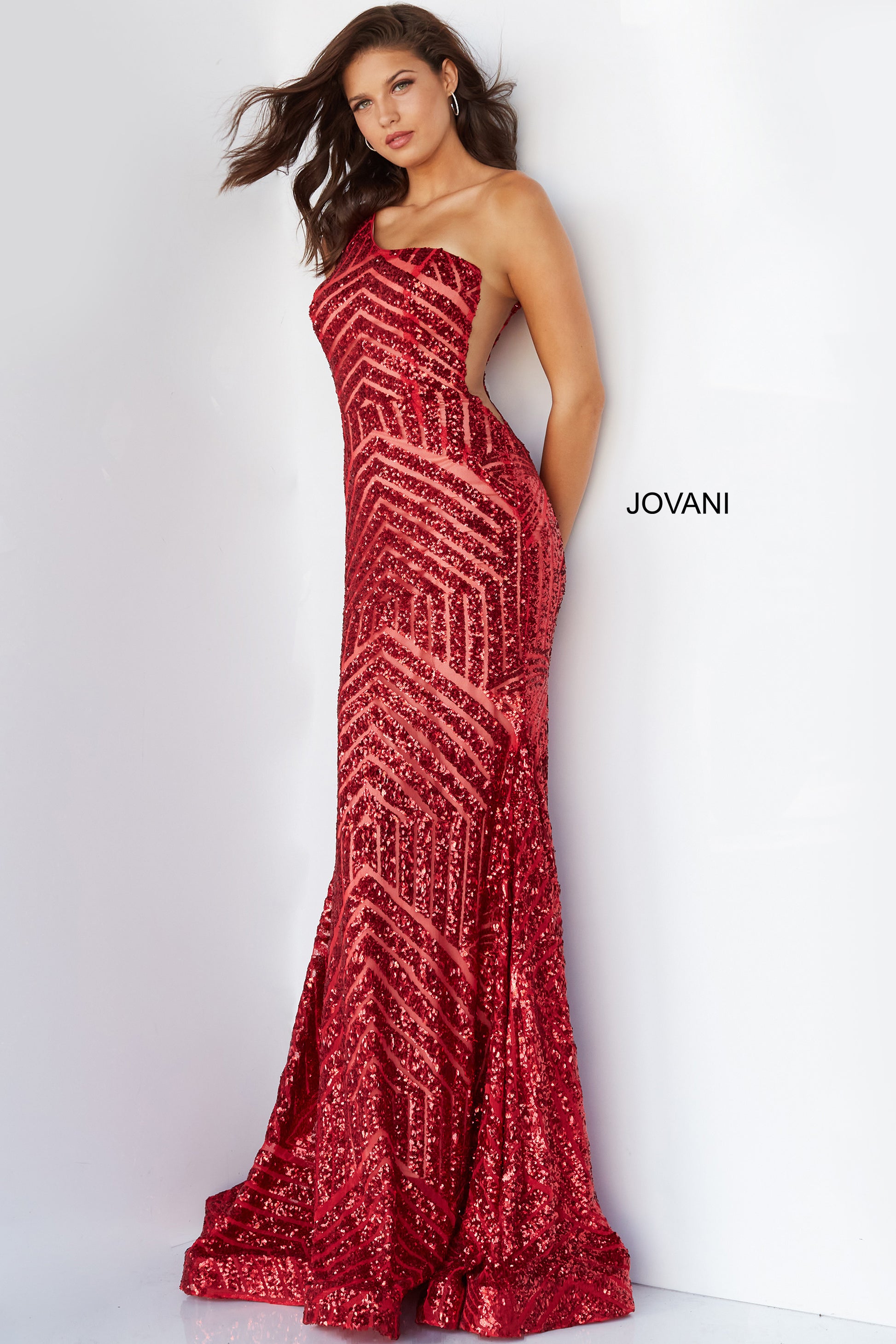 Jovani 06017 Long Mermaid Prom Pageant Gown Sequin One Shoulder Formal Sheer This Jovani 06017 red prom gown features a fit and flare silhouette in geometric sequins, detailed with a one-shoulder neckline and sheer plunging sides. Soft godets add volume to this glitter formal dress, finished with a horsehair hem and sweep train. Available Size-00-24  Available Color- Red, Purple, Blush, Neon Hot Pink