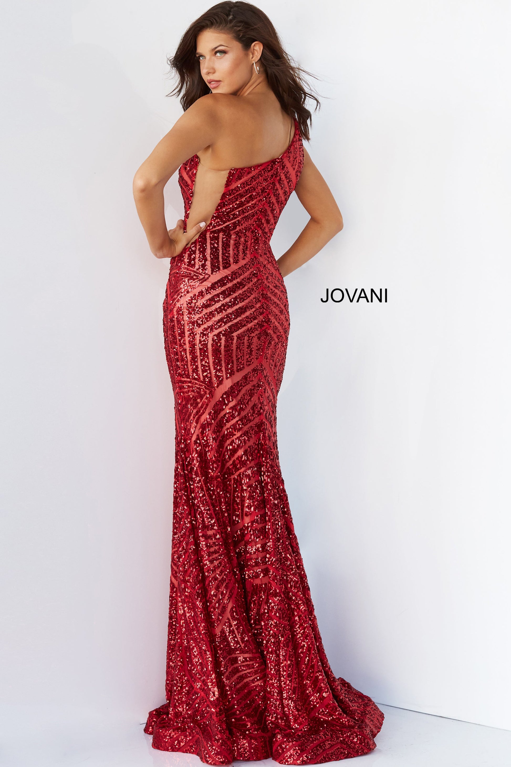 Jovani 06017 Long Mermaid Prom Pageant Gown Sequin One Shoulder Formal Sheer This Jovani 06017 red prom gown features a fit and flare silhouette in geometric sequins, detailed with a one-shoulder neckline and sheer plunging sides. Soft godets add volume to this glitter formal dress, finished with a horsehair hem and sweep train. Available Size-00-24  Available Color- Red, Purple, Blush, Neon Hot Pink