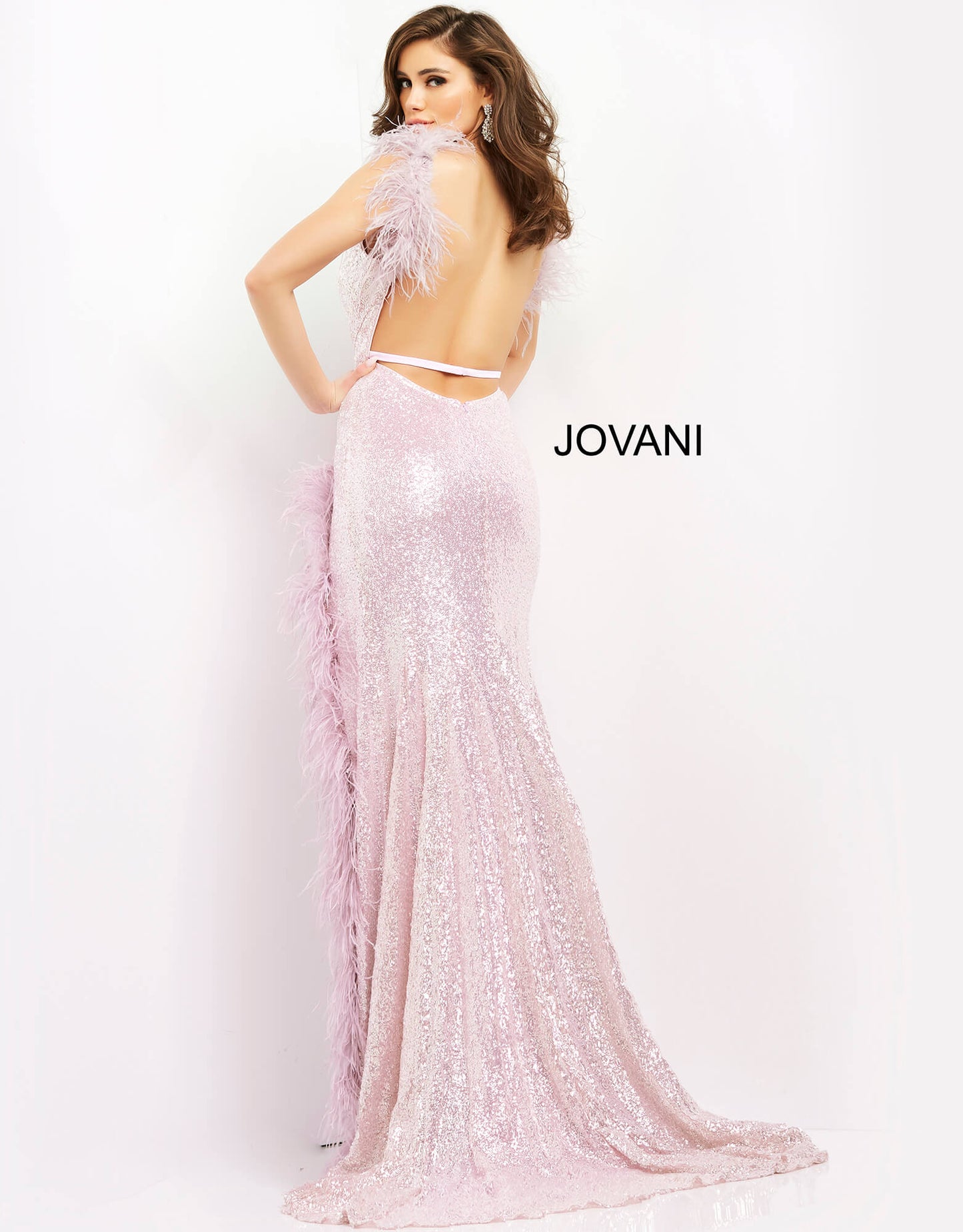 Jovani 06164 This extravagant Prom, Pageant and Evening Gown has a Plunging neckline with feather details on the straps and surrounding the high thigh side slit.  The long prom dress has sequins throughout and has a sexy open back.   Colors  Cream, Lilac  Sizes  00-24