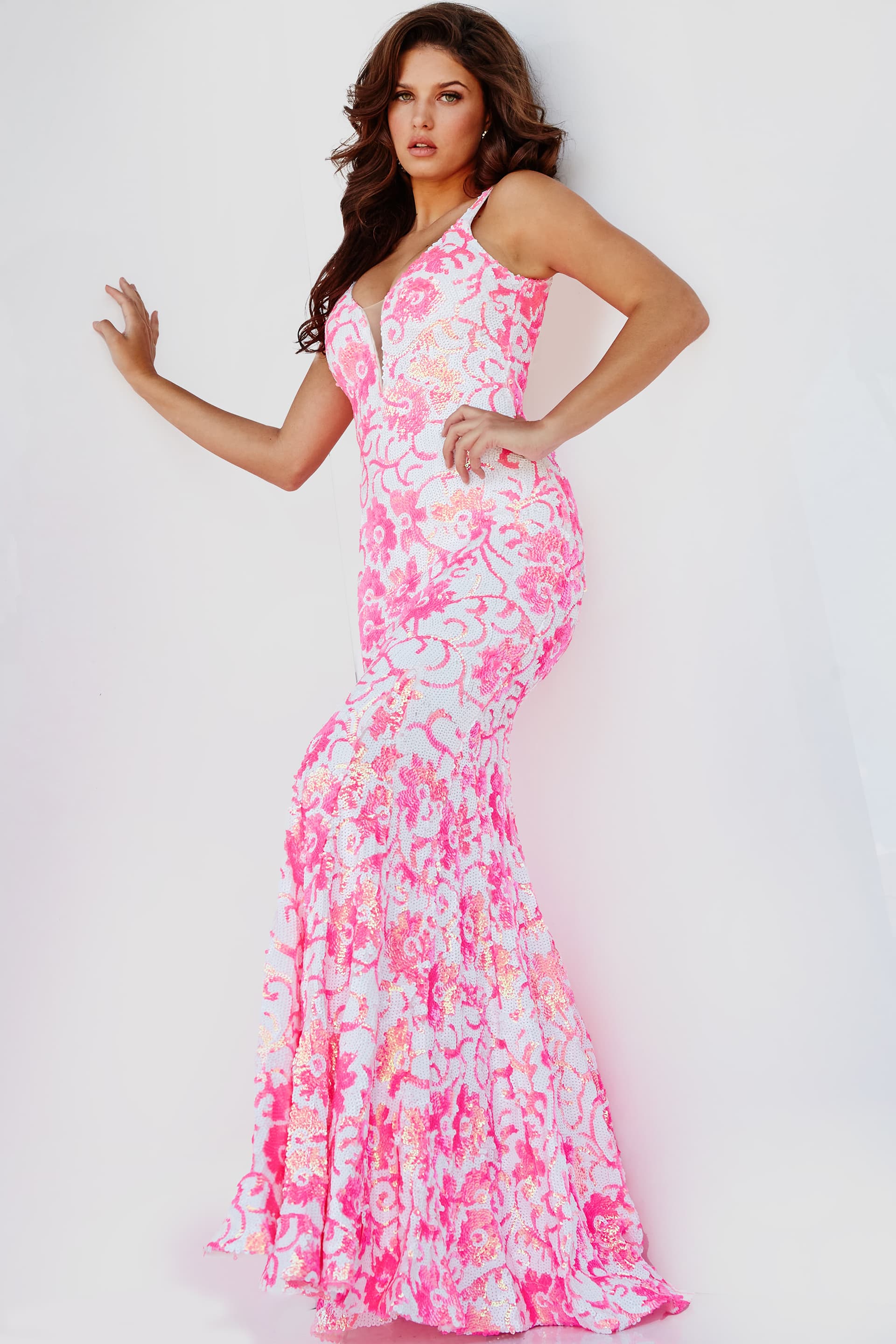 Jovani 08527 is a stunning formal prom & pageant dress. Featuring a floral design in sequin accents. Plunging V neckline. Lush sweeping train & Open midrise back. Great Gown for any formal event! This gown reveals a mermaid silhouette lavishly studded with floral sequin embellishment throughout finished with a sweep train.   Available Sizes: 00,0,2,4,6,8,10,12,14,16,18,20,22,24  Available Colors: Ivory/Purple, Ivory/Orange, Ivory/Emerald