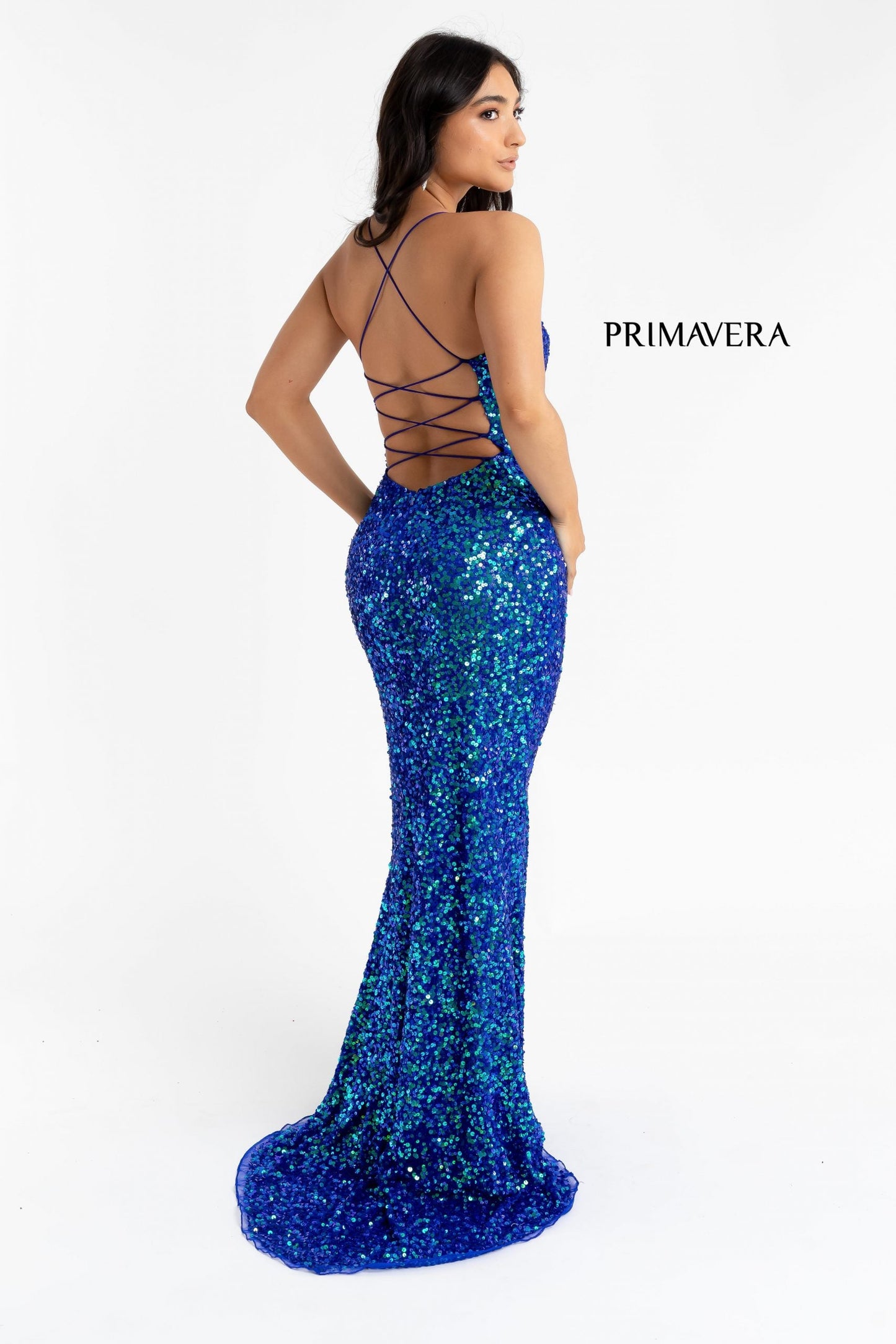 Primavera Couture 3290 This prom dress adds a pop to the multi sequins dress.  With a scoop neckline and spaghetti straps that cross and tie in the back.  This long evening dress has a side slit. 